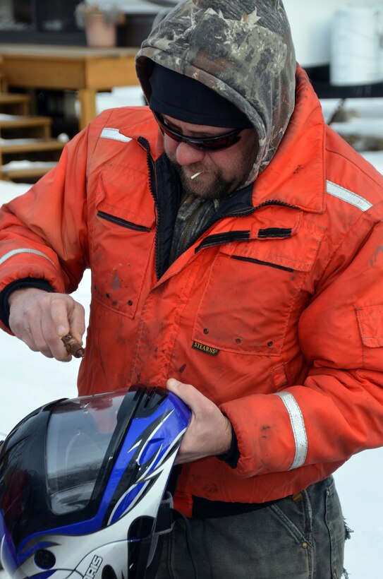WABASHA, Minn. – Bill Chelmowski, U.S. Army Corps of Engineers, St. Paul District marine machinery mechanic applies anti-fog fluid to his helmet prior  to going on Lake Pepin, near Wabasha, Minn., Feb. 13, during the first Mississippi River ice surveys of the year. The district conducts the annual ice surveys to help the navigation industry determine when it is safe to break through the ice. Lake Pepin, located on the Mississippi River between Red Wing and Wabasha, Minn., is used as the benchmark because the ice melts slower in this area due to the lake width and the slower current.