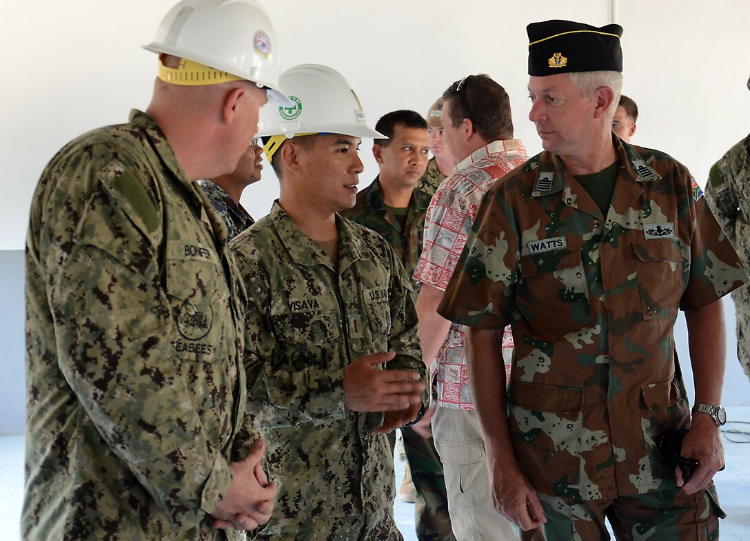 U.S. Navy Ensign Jacky Visava talks about the structure that his team, in coordination with Thai and Malaysian engineers, built for the Ban Piang School in Ban Mae, Kingdom of Thailand with South African Navy, Capt. Neil Watts, senior staff officer maritime operations. Humanitarian and civil assistance projects conducted during CG 13 support the needs and humanitarian interests of our friends and regional partners. (U.S. Army photo by Sgt. Rory Featherston/Released)