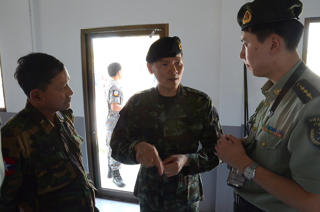 Royal Thai Navy Col. Saniroj Thumayos, the Royal Thai Senior Planner for exercise Cobra Gold 2013 (center) discuses the importance of humanitarian assistance during CG 13 with Burmese Army Maj. Gen. San Myint deputy chief of armed forces training joint warfare training department, (left) and the Peoples Republic of China Capt. Guo Dong Guartgzhou Military Region Interpreter (right). CG 13, in its 32nd iteration, is a multinational exercise that promotes regional prosperity, security and cooperation among partner militaries. (U.S. Army photo by Sgt. Rory Featherston/Released)