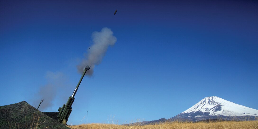 Marines fire high-angle shots from M777 A2 155 mm howitzers Jan. 31 in the East Fuji Maneuver Area during Exercise Fire Dragon 13-2. During the live-fire portion of the exercise, Marines practiced firing at various angles to increase their ability to provide fire support to maneuver elements. The Marines are with 3rd Battalion, 12th Marine Regiment, 3rd Marine Division, III Marine Expeditionary Force. 