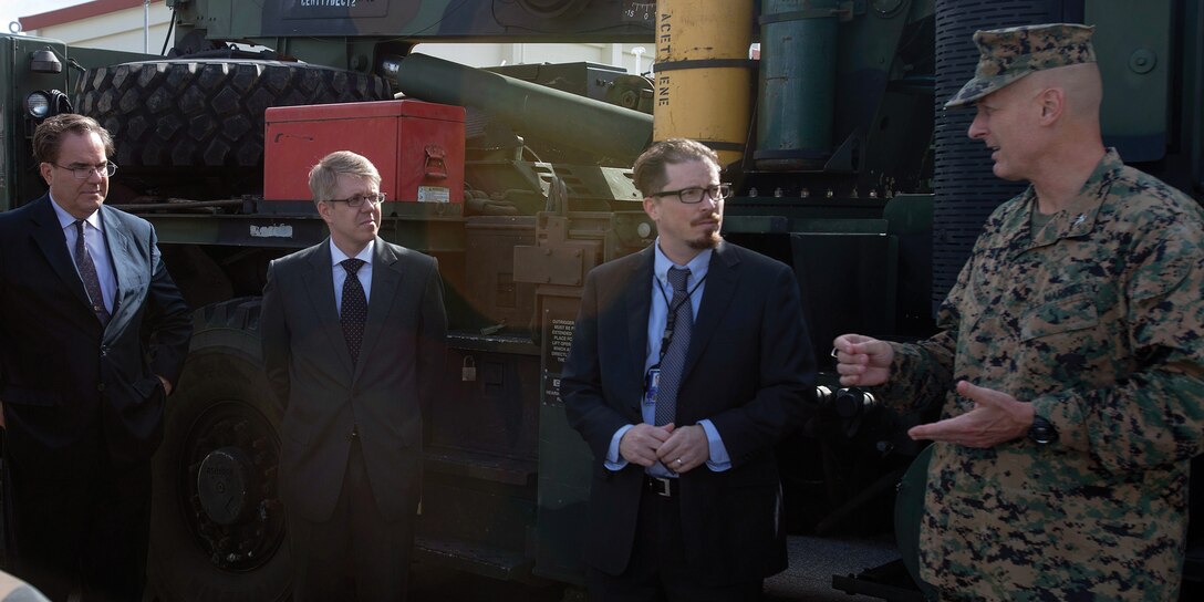 Col. John E. Kasperski, right, discusses some of the functions of Combat Logistics Regiment 35 Feb. 5 at Camp Kinser with, left to right, Alfred R. Magleby, Matt O’Connor and John E. Buhler of the Consulate General’s office, Naha. Magleby and his colleagues visited the camp to gain a better understanding of some of its functions. Kasperski is the Camp Kinser commander and Magleby is the consul general, Naha.