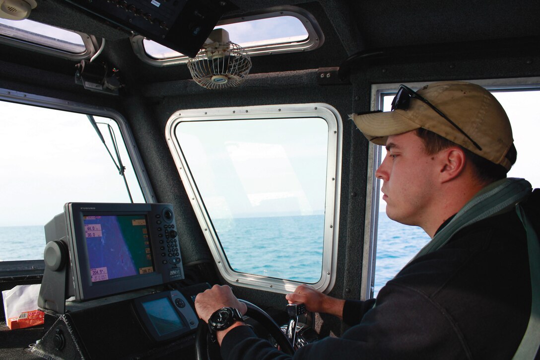 Sgt. Johnathon C. Beck navigates using an onboard computer Feb. 7 at White Beach Naval Facility during a safety boat qualification course. The weeklong course familiarized students with the operation and upkeep of safety boats. Beck is a reconnaissance man with 3rd Reconnaissance Battalion, 3rd Marine Division, III Marine Expeditionary Force.  