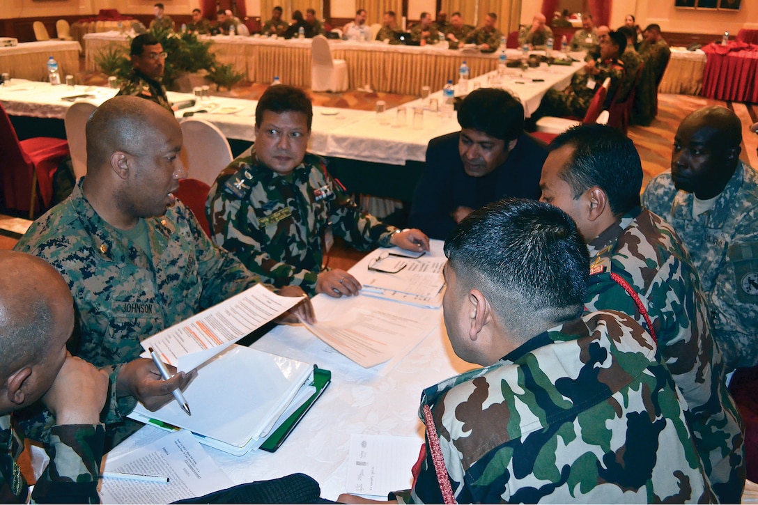 Maj. Jason Johnson discusses courses of action for responding to a simulated earthquake with members of the government of Nepal, Nepalese Army and U.S. Army Pacific Feb. 5 in Katmandu, Nepal, during the Nepal humanitarian assistance and disaster relief table-top exercise. The purpose of the exercise, conducted Feb. 2-8, was to improve III Marine Expeditionary Force’s ability to respond to an HADR scenario in Nepal through coordination and planning with the government of Nepal, U.S. Departments of Defense and State, international and national agencies, and multinational parties. Johnson is a civil affairs officer with III MEF. 