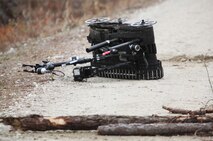 An explosive ordnance disposal robot lays damaged at the site of a simulated improvised explosive device detonation during 2nd Explosive Ordnance Disposal Company, 2nd Marine Logistics Group’s predeployment training at Camp Davis, N.C., Feb. 12, 2013. EOD technicians retrieved the robot from the scene after clearing the area of additional IEDs.