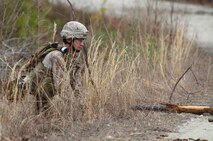 Staff Sgt. James A. Arbuthnot, a technician with 2nd Explosive Ordnance Disposal Company, 2nd Marine Logistics Group, surveys a road during the unit’s predeployment training aboard Camp Davis, N.C., Feb. 12, 2013. Arbuthnot and his team member reported to the scene of an improvised explosive device detonation, where they carefully sifted through the area with metal detectors before clearing the road with a simulated explosive charge. 
