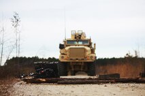Debris from a simulated improvised explosive device blocks a road during 2nd Explosive Ordnance Disposal Company, 2nd Marine Logistics Group’s IED training at Camp Davis, N.C., Feb. 12, 2013. Two Marines with 2nd EOD Co. cleared the area with metal detectors before moving onto the road and ensuring it was safe for vehicles to pass.