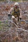 A Marine with 2nd Explosive Ordnance Disposal Company, 2nd Marine Logistics Group clears a path to a road with a metal detector during the unit’s training operation at Camp Davis, N.C., Feb. 12, 2013. The Marines used the metal detectors to search for improvised explosive devices that could be hidden under the thick layers of vegetation and debris encompassing the area. 