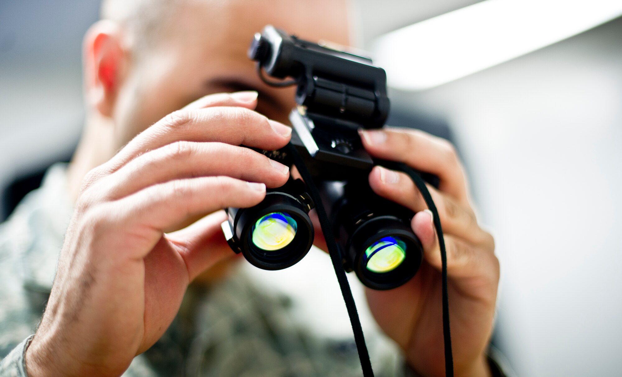 YOKOTA AIR BASE, Japan -- Senior Airman Phillip Rodriguez, 374th Operations Support Squadron aircrew flight equipment journeyman, inspects night vision goggles at Yokota Air Base, Japan, Feb. 14, 2013. (U.S. Air Force photo by Staff Sgt. Stacy Moless)