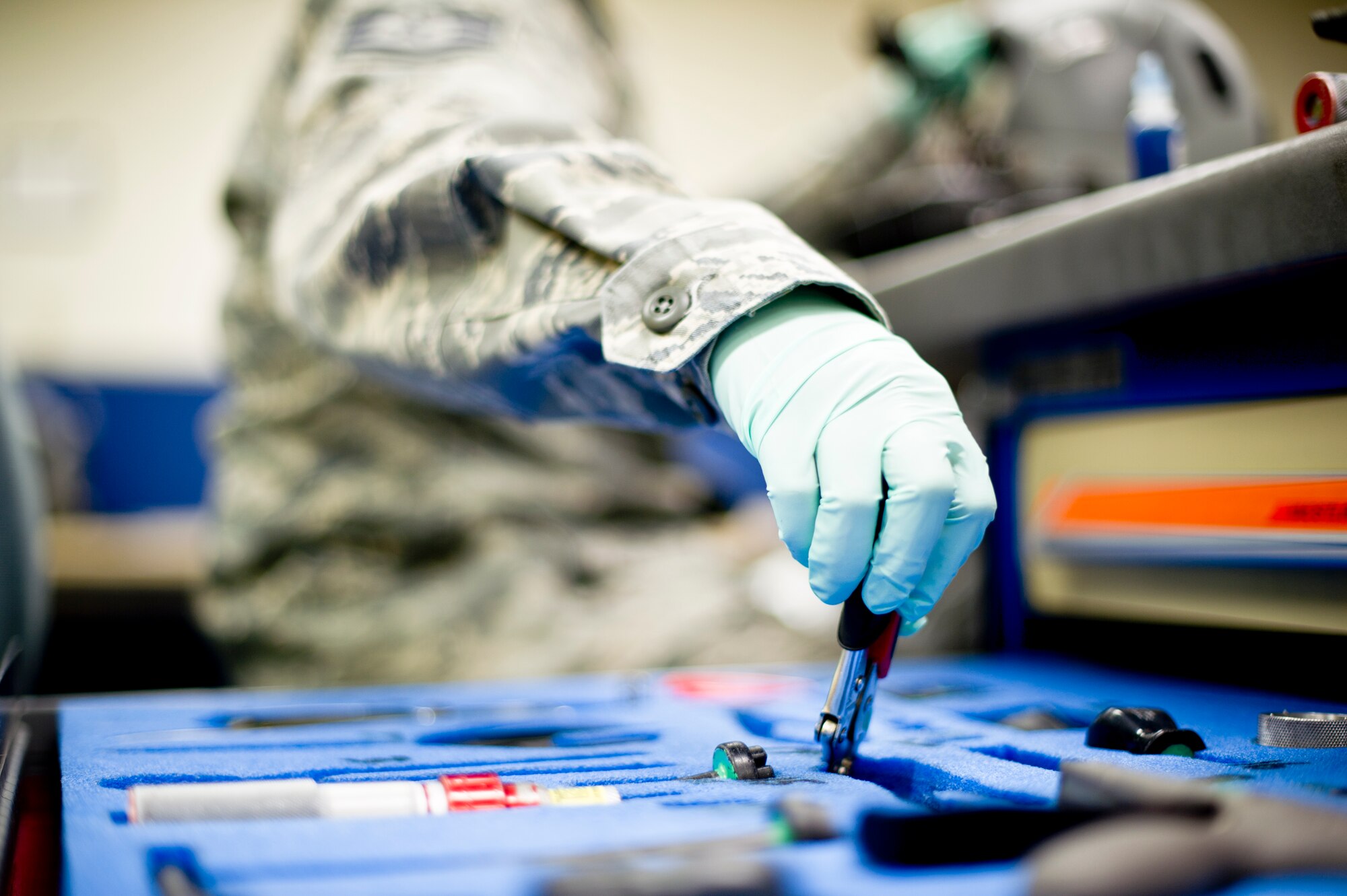YOKOTA AIR BASE, Japan -- Tech. Sgt. Rhodelyn Merculio, 374th Operations Support Squadron aircrew flight equipment journeyman, reaches for a tool while inspecting a helmet at Yokota Air Base, Japan, Feb. 14, 2013.  Aircrew flight equipment technicians ensure life-saving survival equipment used by aircrew members is properly functioning by maintaining all the equipment with routine inspections. (U.S. Air Force photo by Staff Sgt. Stacy Moless) 
