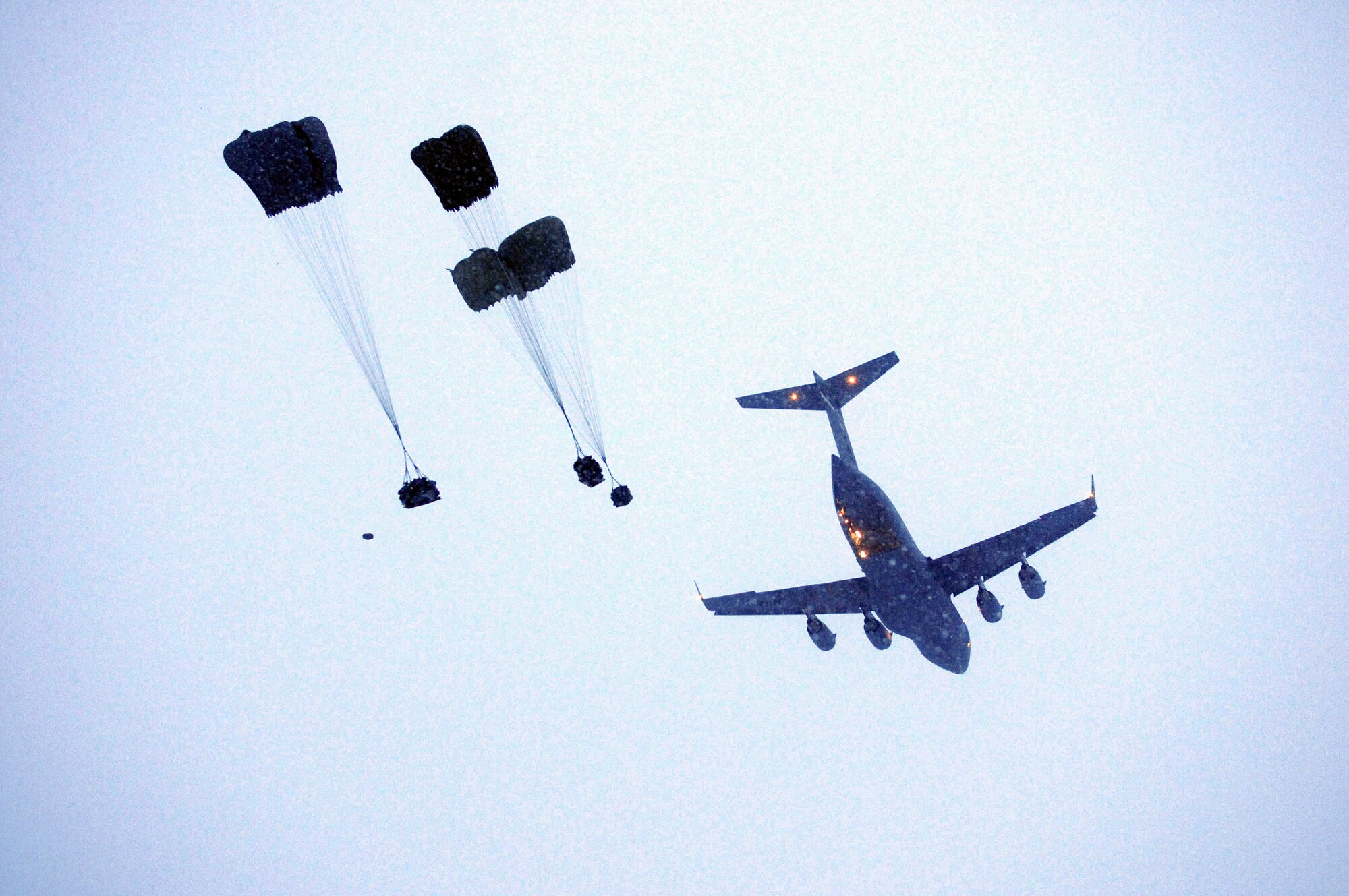 A flight crew with the Alaska Air National Guard's 249th Airlift Squadron conducts an equipment drop from a C-17 Globemaster III during an arctic search-and-rescue exercise Feb. 8, 2013. (Photo by Sgt. Edward Eagerton, Alaska Army National Guard)