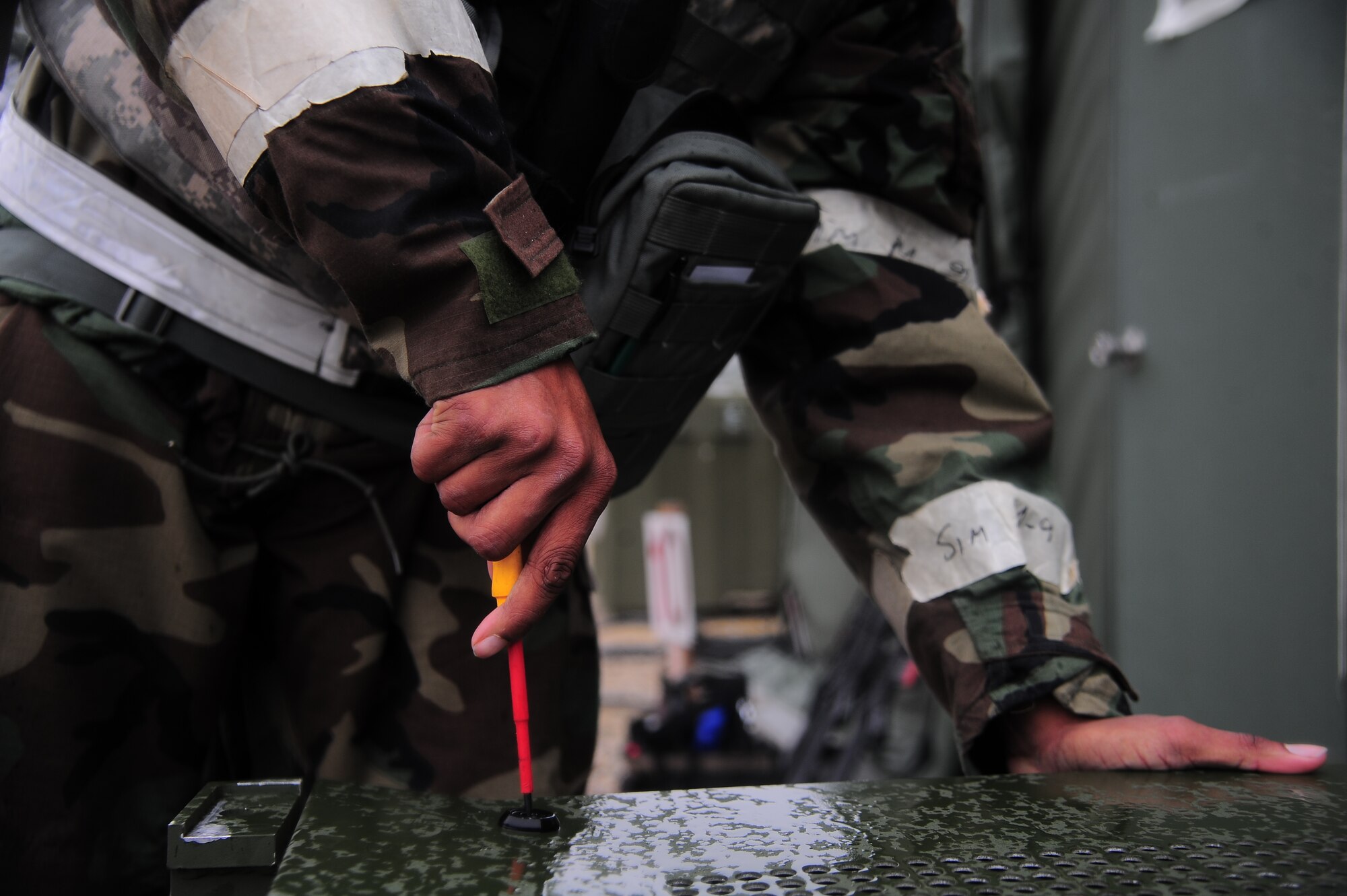 U.S. Air Force Staff Sgt. Charles Martinez, 4th Civil Engineer Squadron heating, ventilation and air conditioning technician, secures the lid to an environmental control unit during Operational Readiness Exercise Coronet Warrior 13-02, at a simulated deployed location on Seymour Johnson Air Force Base, N.C., Feb. 13, 2013. A unit is attached to each Base X tent and is used to control heating and air conditioning levels. (U.S. Air Force photo/Airman 1st Class Aubrey White/Released)