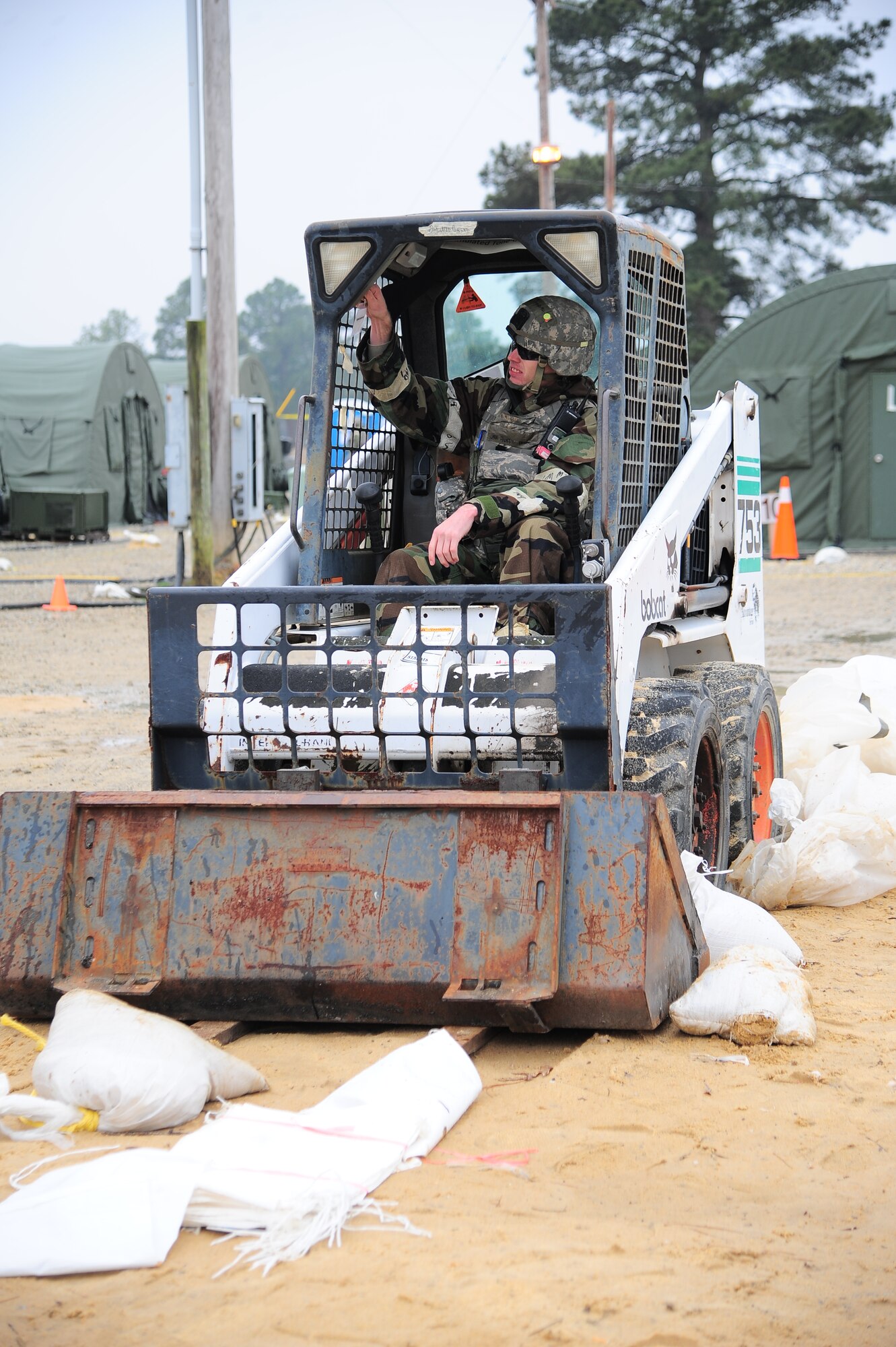 U.S. Air Force Senior Airman Austin Thornton, 4th Civil Engineer Squadron pavement and equipment technician, moves an environment control unit prior to replacement during Operational Readiness Exercise Coronet Warrior 13-02, at a simulated deployed location on Seymour Johnson Air Force Base, N.C., Feb. 13, 2013. Several Airmen assigned to the 4th CES were tasked to replace a faulty environment control unit at the Base X dining facility. (U.S. Air Force photo/Airman 1st Class Aubrey White/Released)