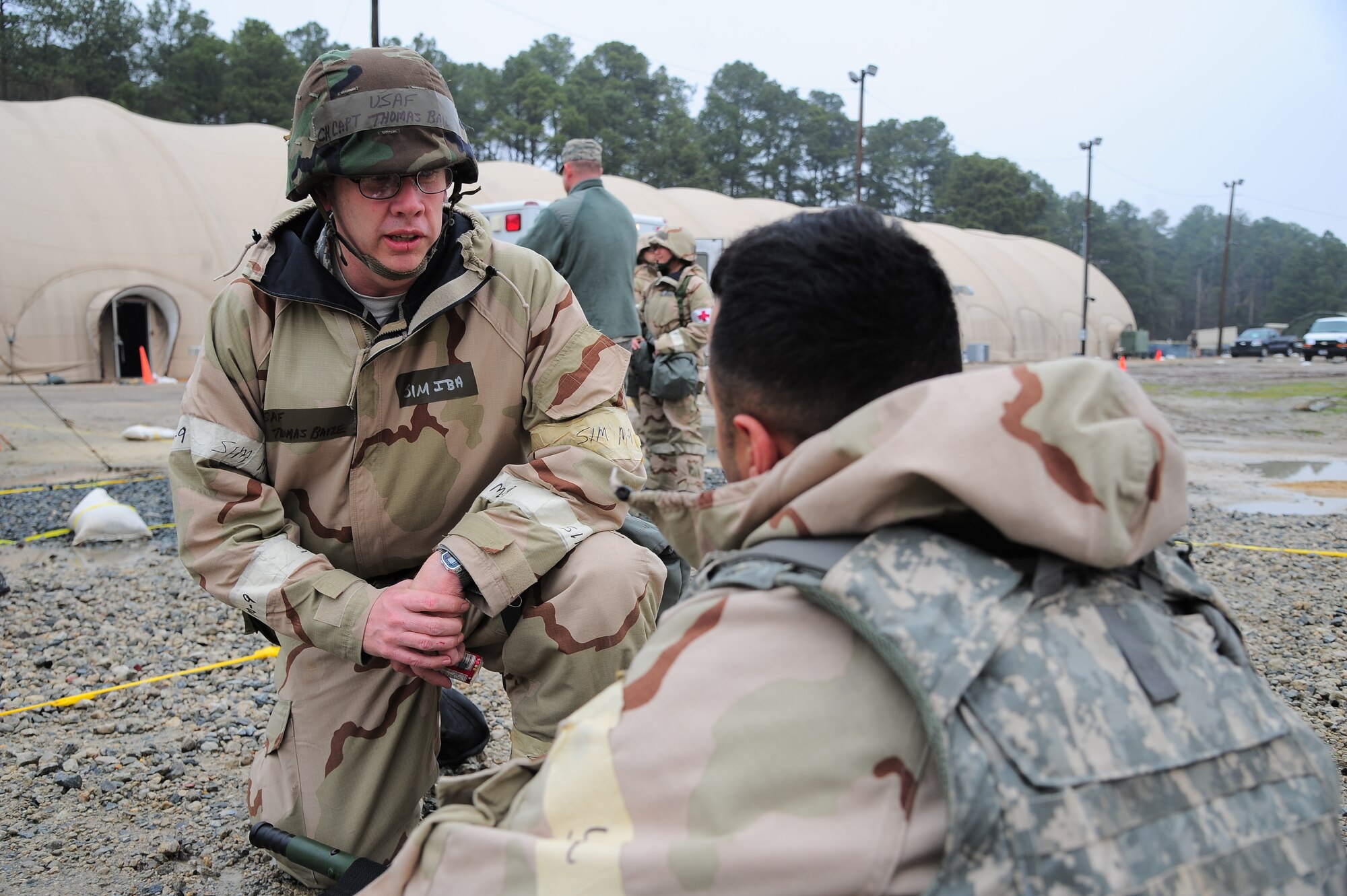 U.S. Air Force Chaplain (Capt.) Thomas Baize, speaks to an injured Airman during Operational Readiness Exercise Coronet Warrior 13-02, at a simulated deployed location on Seymour Johnson Air Force Base, N.C., Feb. 13, 2013. Chaplains and their assistants perform wellness checks on Airmen to increase morale during deployments. (U.S. Air Force photo/Airman 1st Class Aubrey White/Released)