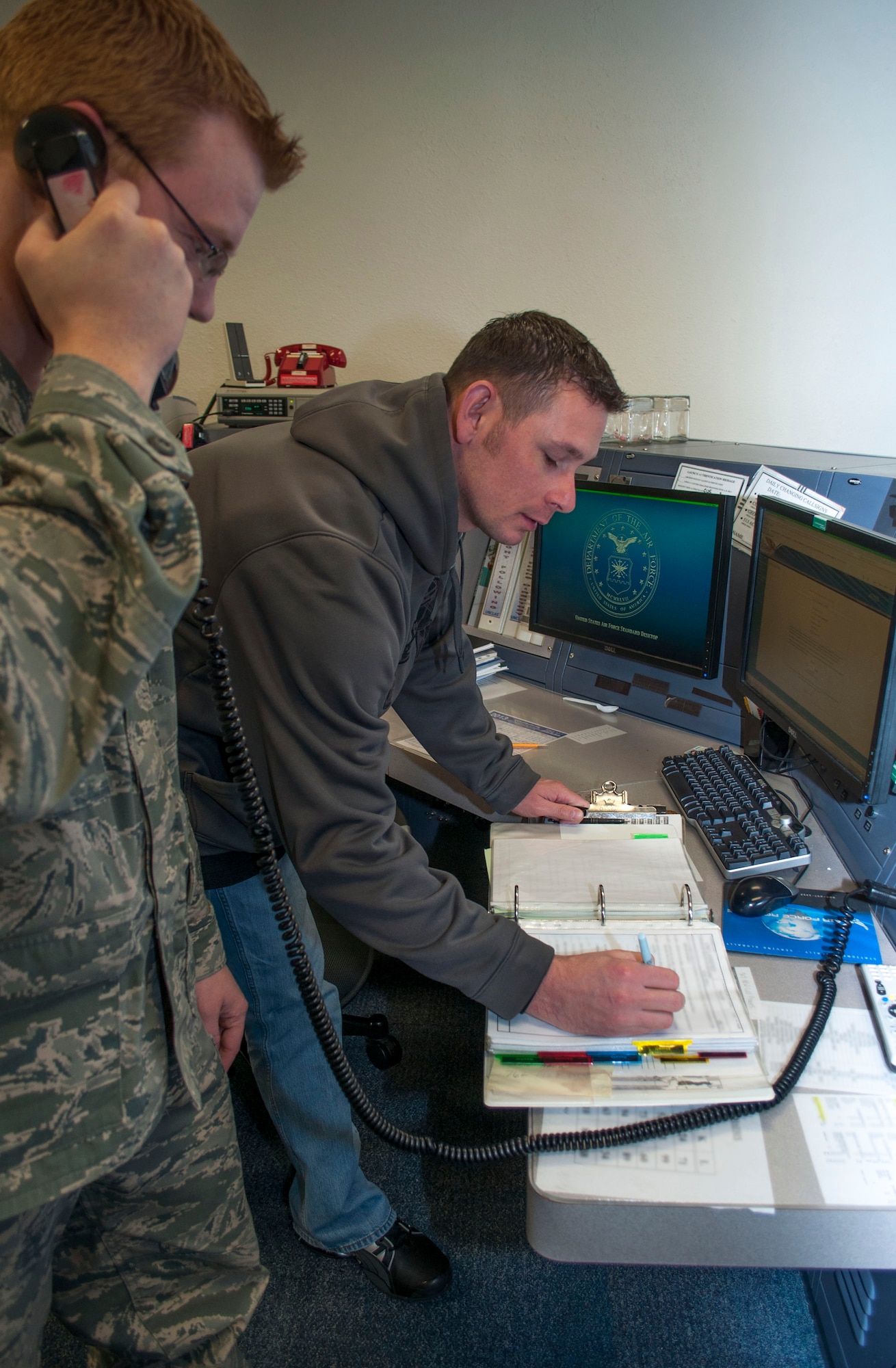 Tech. Sgt. Jason Brown (right), 507th Air Refueling Wing command post specialist and Staff Sgt. Erik Orr, 137th ARW command post specialist work jointly on a emergency response checklist.  The “Sooner Control” command post is the only joint guard and reserve command post with a nuclear mission in the Air Force. (U.S. Air Force Photo by Senior Airman Mark Hybers)