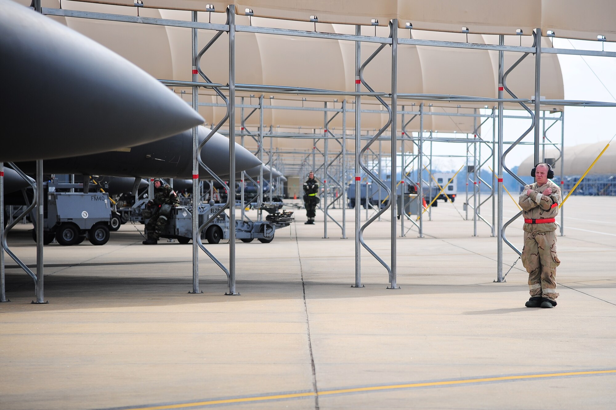 U.S. Air Force Airmen assigned to the 4th Aircraft Maintenance Squadron signal for aircrew members to hold the brakes prior to taxi at a simulated deployed location during Operational Readiness Exercise Coronet Warrior 13-02 on Seymour Johnson Air Force Base, N.C., Feb. 14, 2013. Crew chiefs are responsible for ensuring all aircraft maintenance is complete and up-to-date prior to marshalling the F-15E Strike Eagles to the flight line. (U.S. Air Force photo/Airman 1st Class Aubrey White/Released)