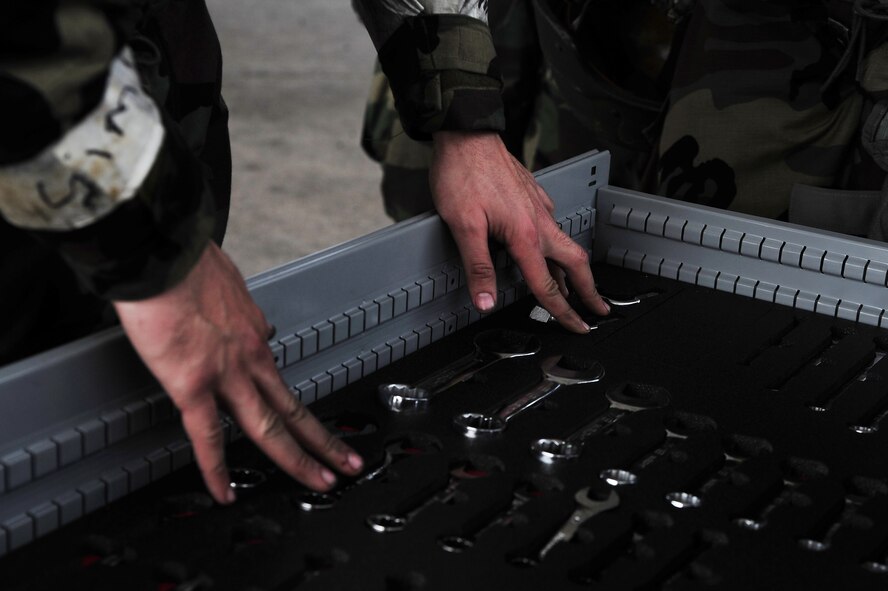 A U.S. Air Force Airman assigned to the 4th Aircraft Maintenance Squadron searches through a tool box during Operational Readiness Exercise Coronet Warrior 13-02, at a simulated deployed location on Seymour Johnson Air Force Base, N.C., Feb. 14, 2013. Maintainers must work accurately and with a sense of urgency to ensure the structural integrity of each aircraft prior to flight. (U.S. Air Force photo/Airman 1st Class Aubrey White/Released)