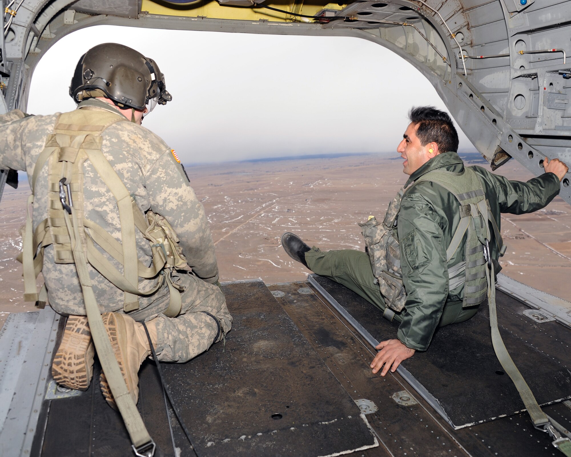 A Royal Jordanian Air Force flight doctor enjoys the view from the back of a Colorado Army National Guard CH-47 Chinook Feb. 6, 2013, a highlight of the week-long State Partnership Program Aviation Safety Exchange in Colorado.  The group flew to and from the 140th Wing’s Airburst Range at Fort Carson, Colo., to have an opportunity to witness the 140th Wing, Colorado Air National Guard’s, safety programs in action. (Air National Guard Photo / Senior Master Sgt. John P. Rohrer)