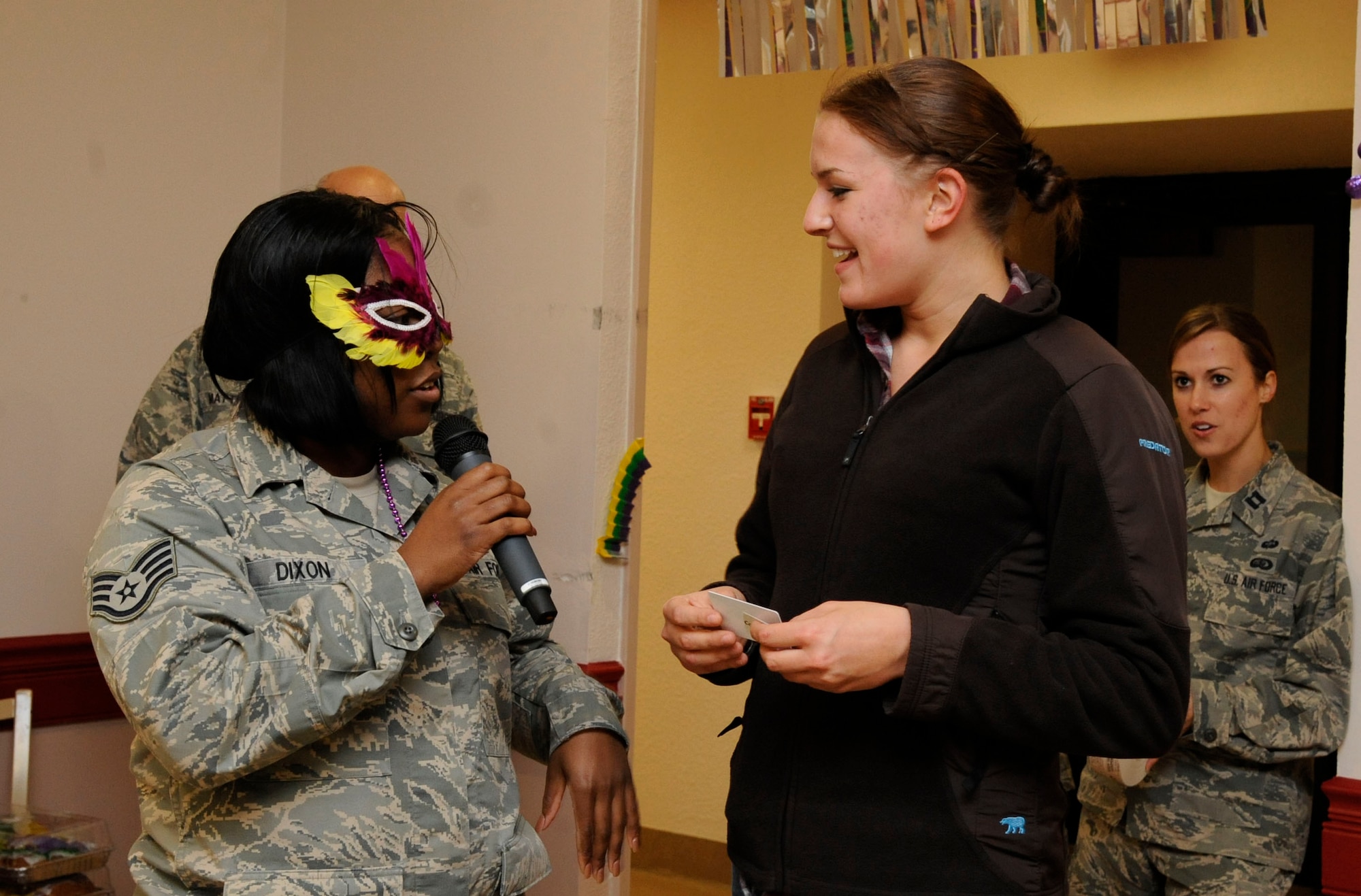 Airman 1st Class Eva Hintz, 2nd Aircraft Maintenance Squadron, receives a prize during the Airmen Birthday Meal from Staff Sgt. Marquish Dixon, 2nd Force Support Squadron, on Barksdale Air Force Base, La., Feb. 13. As Airmen arrived to the event, they were each given a ticket for a raffle where they could win prizes such as gift cards and a free game of golf at the Fox Run golf course. (U.S. Air Force photo/Airman 1st Class Andrew Moua)