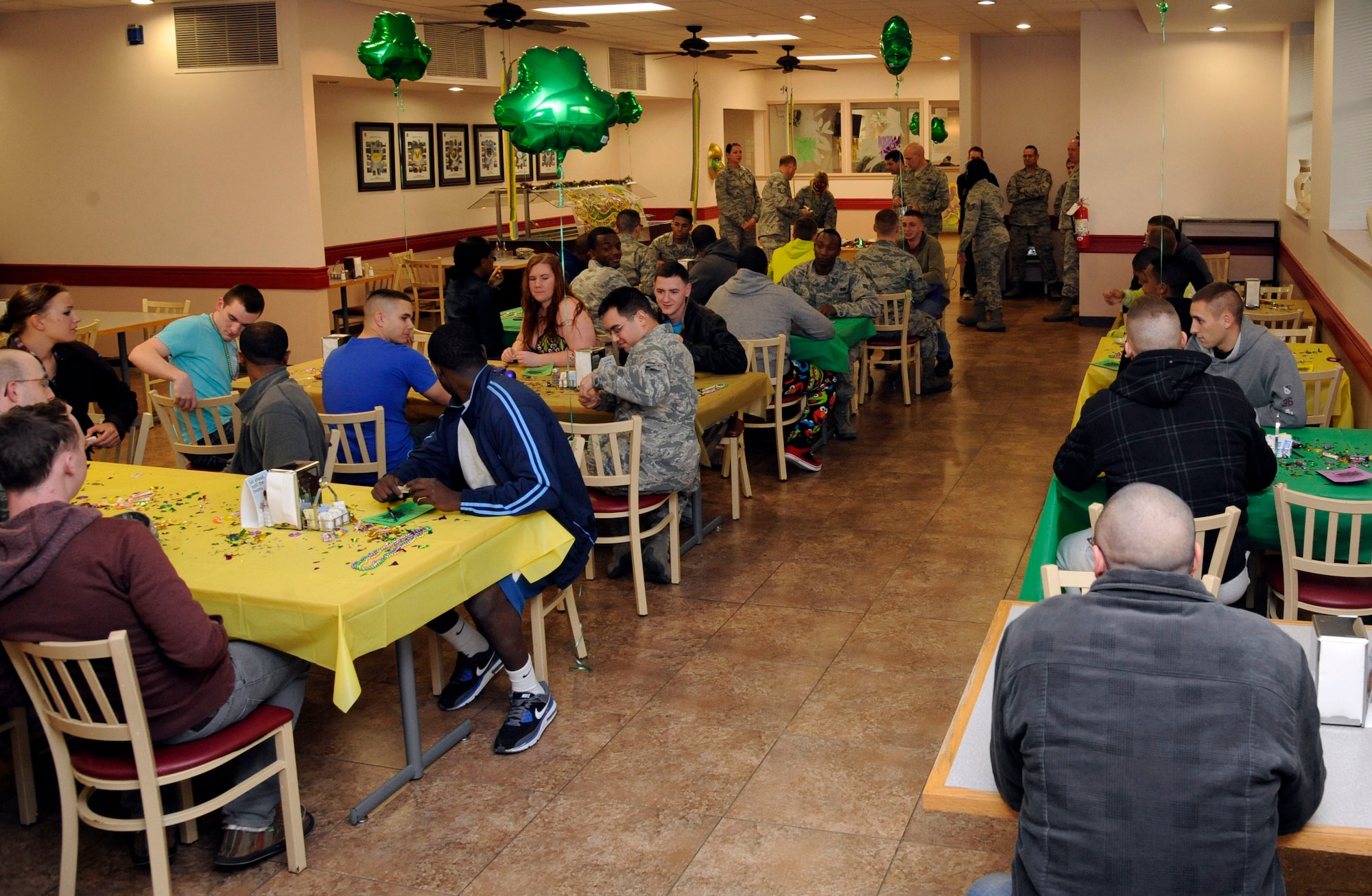 Airmen sit in the Red River Dining Facility as they wait to receive a meal served by squadron first sergeants and commanders during the Airmen Birthday Meal on Barksdale Air Force Base, La., Feb. 13. Airmen were given a choice of three entrees which included T-bone steak, fried shrimp and chicken parmesan along with a choice of sides provided by the 2nd Force Support Squadron. (U.S. Air Force photo/Airman 1st Class Andrew Moua)