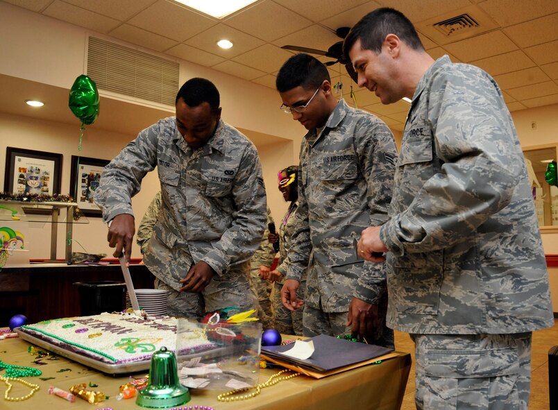 Airman 1st Class Kevin Yator, 2nd Communications Squadron, cuts a birthday cake during the Airmen Birthday Meal as Airman 1st Class Ernesto Maldonado-Rosario, 2nd Force Support Squadron, and Col. Andrew Gebara, 2nd Bomb Wing commander, observe on Barksdale Air Force Base, La., Feb. 13. The Airmen Birthday Meal celebrated Barksdale Airmen's birthdays that fell between October 2012 through March 2013 as a way of appreciating the Airmen's hard work and dedication to the mission. (U.S. Air Force photo/Airman 1st Class Andrew Moua)