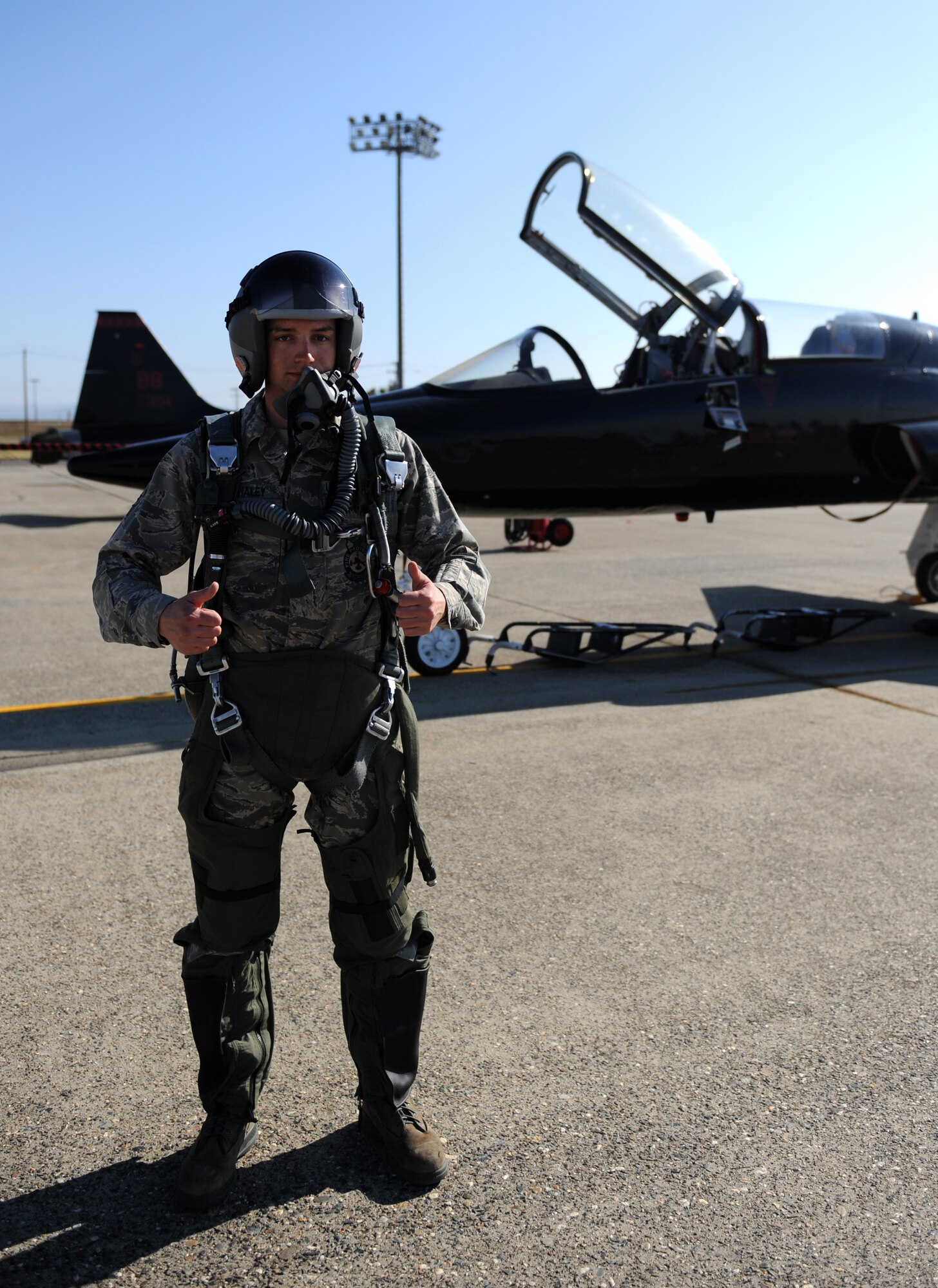 Airman 1st Class Eric Whaley, 9th Civil Engineer Squadron firefighter, poses in front of a T-38 Talon jet trainer on the flight-line at Beale Air Force Base, Calif., Feb. 13, 2013. Whaley portrayed a pilot during a fire department exercise. (U.S. Air Force photo by Staff Sgt. Robert M. Trujillo/Released)