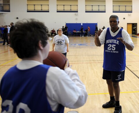 A Special Olympian throws in the ball to a team mate at the Shellbank Fitness Center on Langley Air Force Base, Va., Feb. 9, during the Special Olympics basketball tournament. Thirteen teams from six different districts participated in the games at. (U.S. Air Force photo by Senior Airman Brittany Paerschke-O’Brien/Released) 