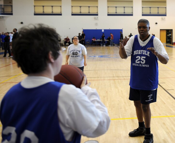 A Special Olympian throws in the ball to a team mate at the Shellbank Fitness Center on Langley Air Force Base, Va., Feb. 9, during the Special Olympics basketball tournament. Thirteen teams from six different districts participated in the games at. (U.S. Air Force photo by Senior Airman Brittany Paerschke-O’Brien/Released) 