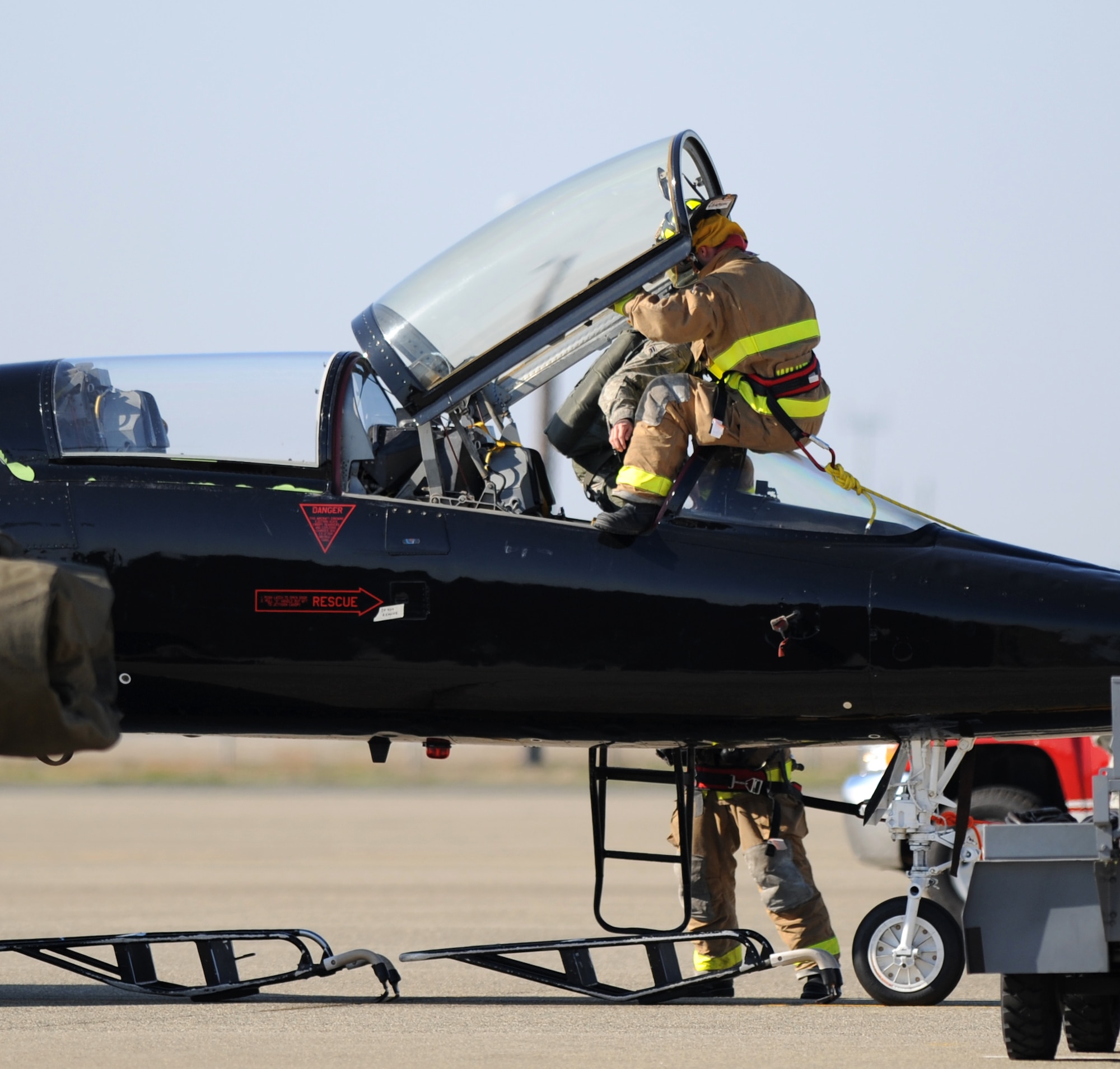 Beale firefighters perform a pilot rescue exercise on the flight-line at Beale Air Force Base, Calif., Feb. 13, 2013. The aircraft used in the exercise is a T-38 Talon jet trainer. (U.S. Air Force photo by Staff Sgt. Robert M. Trujillo/Released)