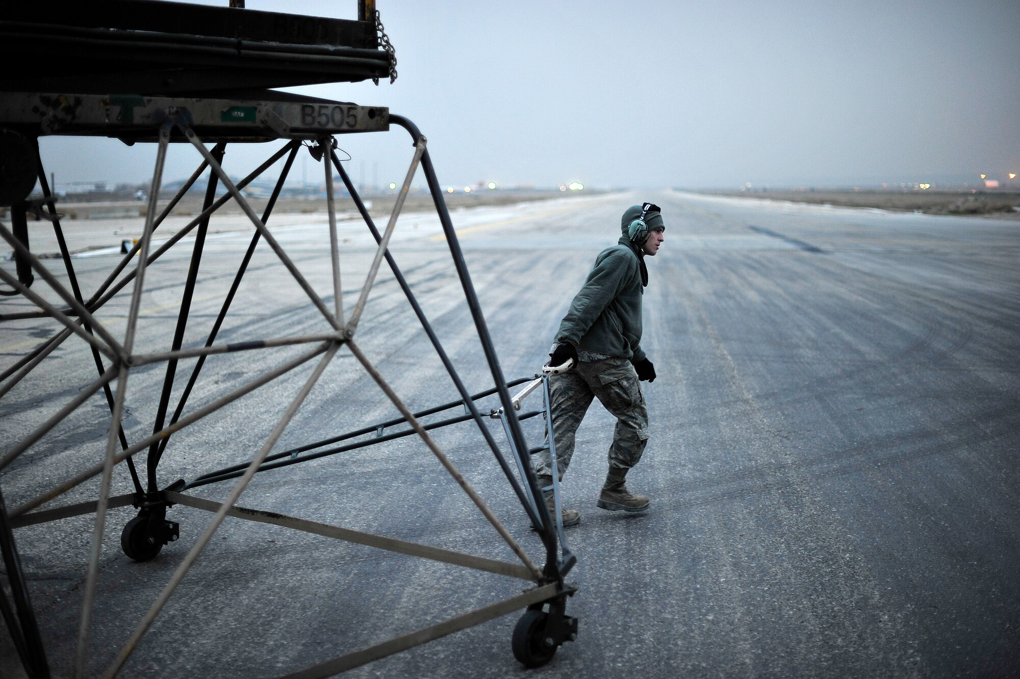 Airman 1st Class Jordan Berarducci drags a maintenance stand into position before inspecting engine oil levels on a C-5M Super Galaxy Jan. 27, 2013, at Camp Marmal, Afghanistan. The aircraft is assigned to the 436th Airlift Wing at Dover Air Force Base, Del., and is forward deployed to assist with the scheduled rotation of two U.S. Army aviation task forces. Berarducci is an aircraft maintenance apprentice assigned to the 436th Airlift Wing at Dover AFB, Del. (U.S. Air Force photo/Tech. Sgt. Parker Gyokeres)