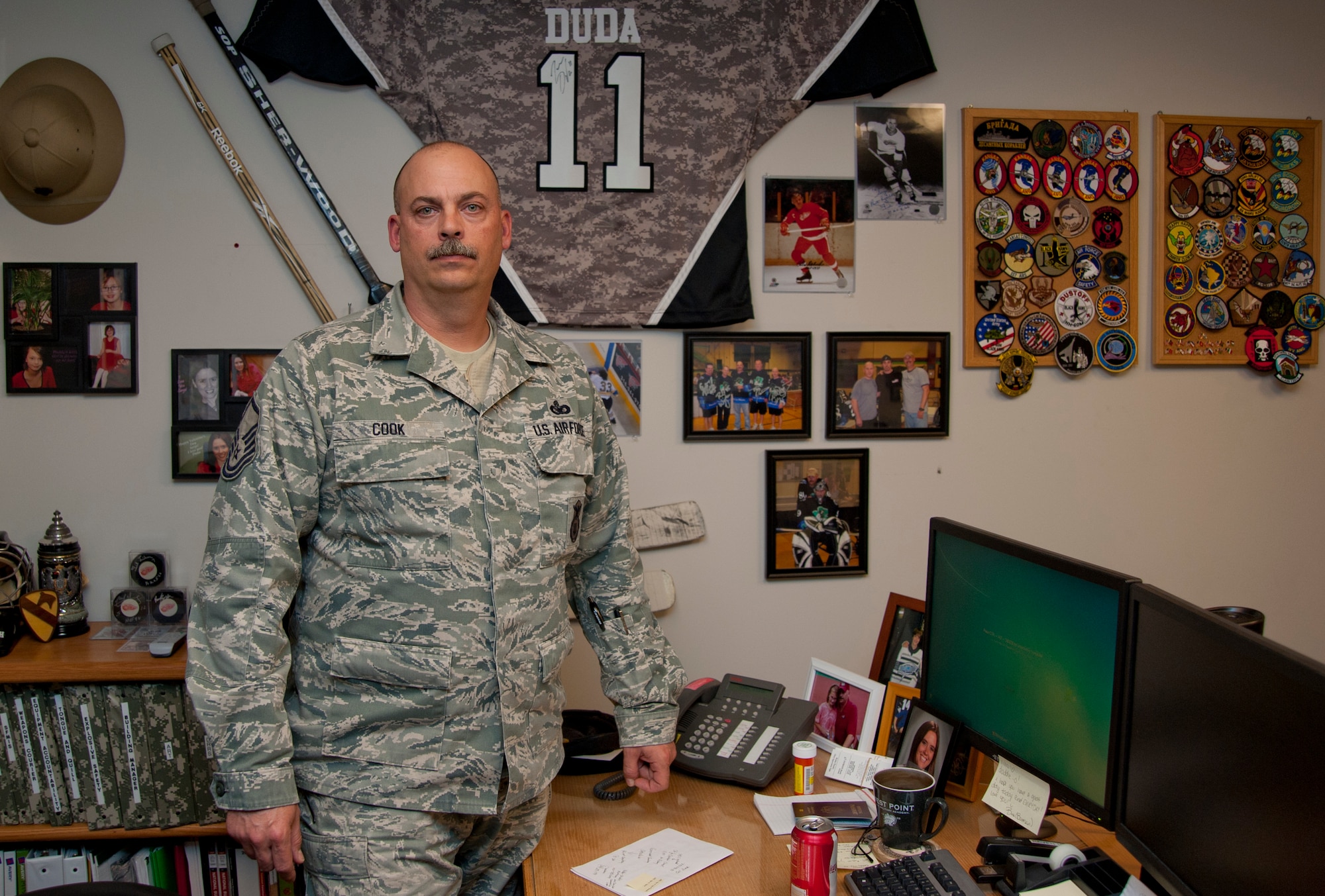 Master Sgt. Frank Cook, 184th Security Forces Squadron supply mobility NCO in charge, stands with a collection of memorabilia he acquired through his career of more than 20 years Feb. 13, 2013, McConnell Air Force Base, Kan. Cook, who spent seven years in the Marine Corps, has been with the Kansas Air National Guard since 1997 when he signed up as a traditional guardsman. (U.S. Air Force photo/Airman 1st Class Victor J. Caputo)