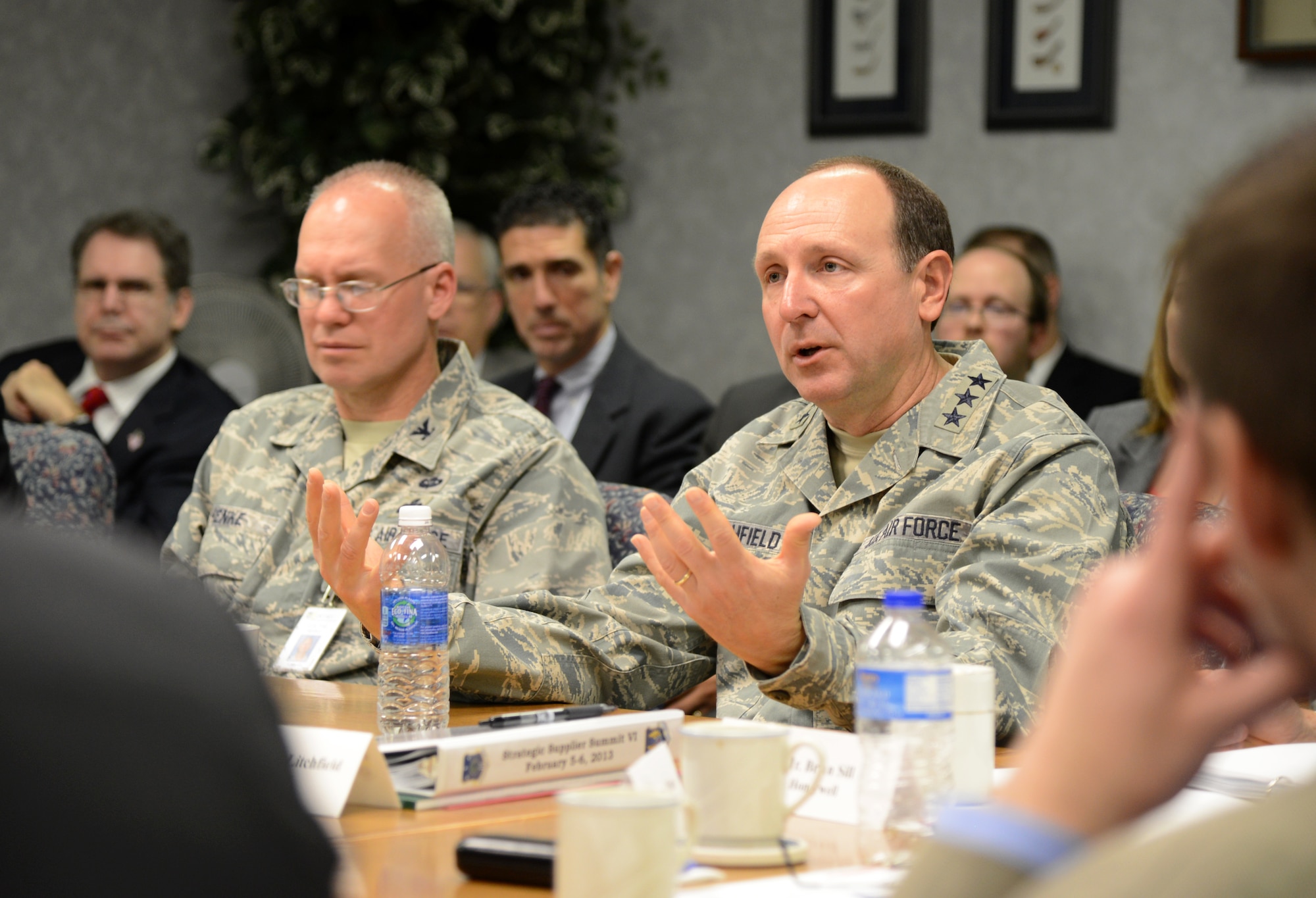 Lt. Gen. Bruce Litchfield, Air Force Sustainment Center commander, addresses a room of Air Force supply chain professionals and industry partners at the Strategic Supplier Summit held here Feb. 5-6. To open the two-day summit, General Litchfield discussed ways that Tinker is rapidly improving supply chain effectiveness and efficiencies and directed the room to discuss ways to save money while maintaining current capabilities. The summit’s focus, according to Col. Tim Henke, 448th Supply Chain Management Wing commander and host of the conference, on the general’s right, was for the military and its suppliers to become better at collaborative planning. (Air Force photo by Kelly White)