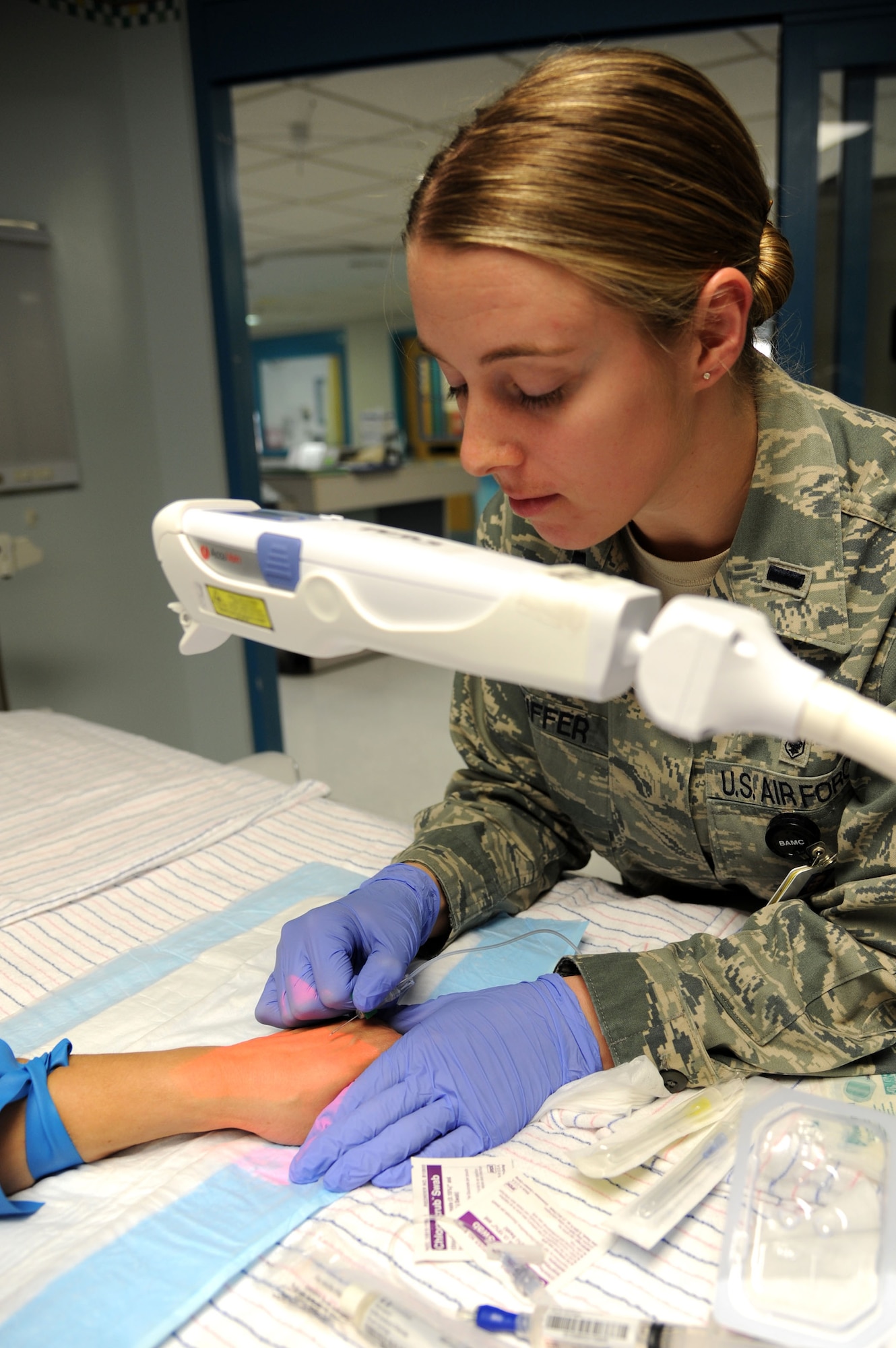 1st Lt. Meredith Peiffer, a critical care nurse fellow with the 59th Training Squadron, prepares an IV drip in the pediatric intensive care unit at University Health System Feb. 7.  The recent partnership between the 59th Medical Wing and UHS is the first of its kind, developing highly skilled nurses for humanitarian and peacetime missions. (U.S. Air Force Photo/Staff Sgt. Micky M. Bazaldua)