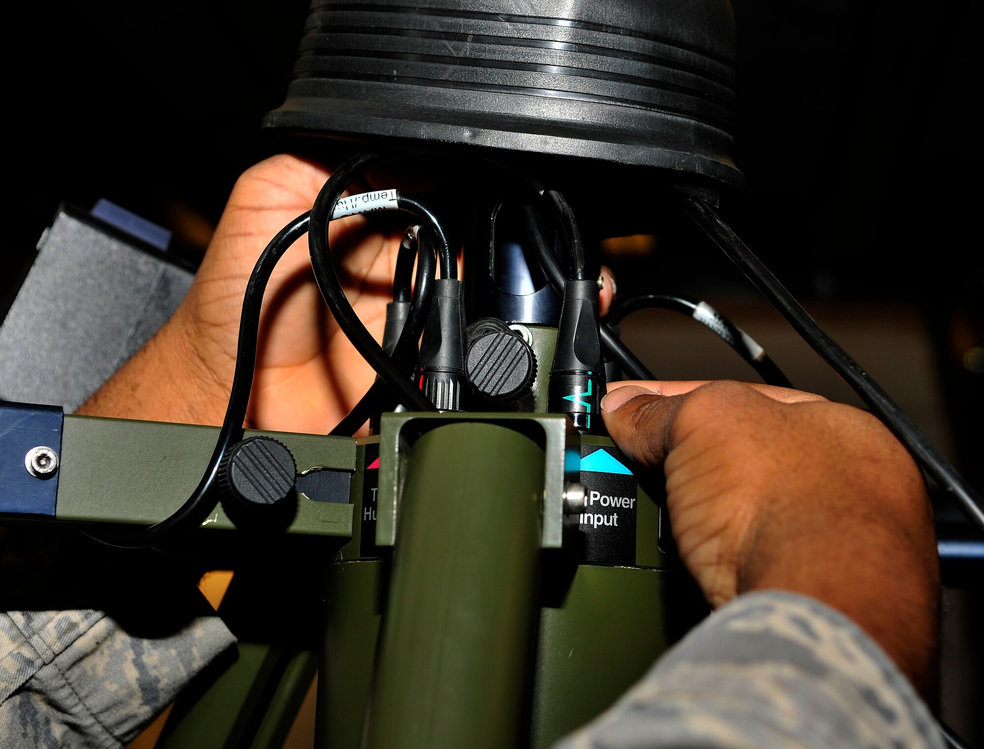 U.S. Air Force Staff Sgt. Ramel Wyke, 354th Operations Support Squadron weather technician, inspects the wiring on a Tactical Meteorological Observing System Feb. 6, 2013, Eielson Air Force Base, Alaska. TMOS is a portable electronic weather station used in deployed locations to measure meteorological data, to include amount of rainfall, wind speeds and cloud cover.  (U.S. Air Force photo/Senior Airman Racheal E. Watson)