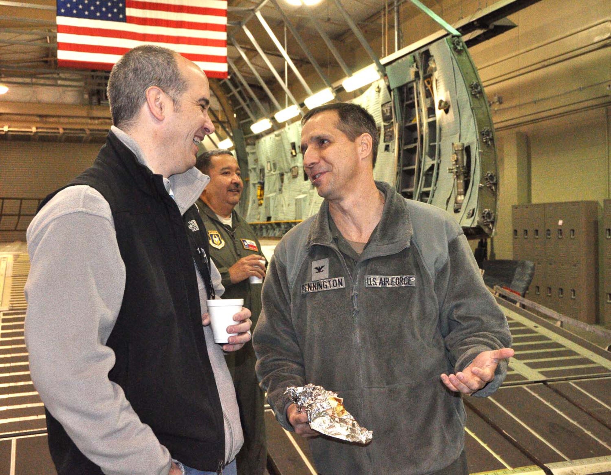 Col. Jeffrey Pennington, 433rd Airlift Wing commander, right, shares a laugh with Jeffrey Downing, Enterprise Holdings Human Resource Manager in San Antonio, and 74th Aerial Port Squadron honorary commander, at the 13th Annual Rodeo Round-Up Breakfast here Feb. 14. The free breakfast is a spin-off of the annual San Antonio Stock & Rodeo Show. (U.S. Air Force photo by 1st Lt. Denise Haeussler)