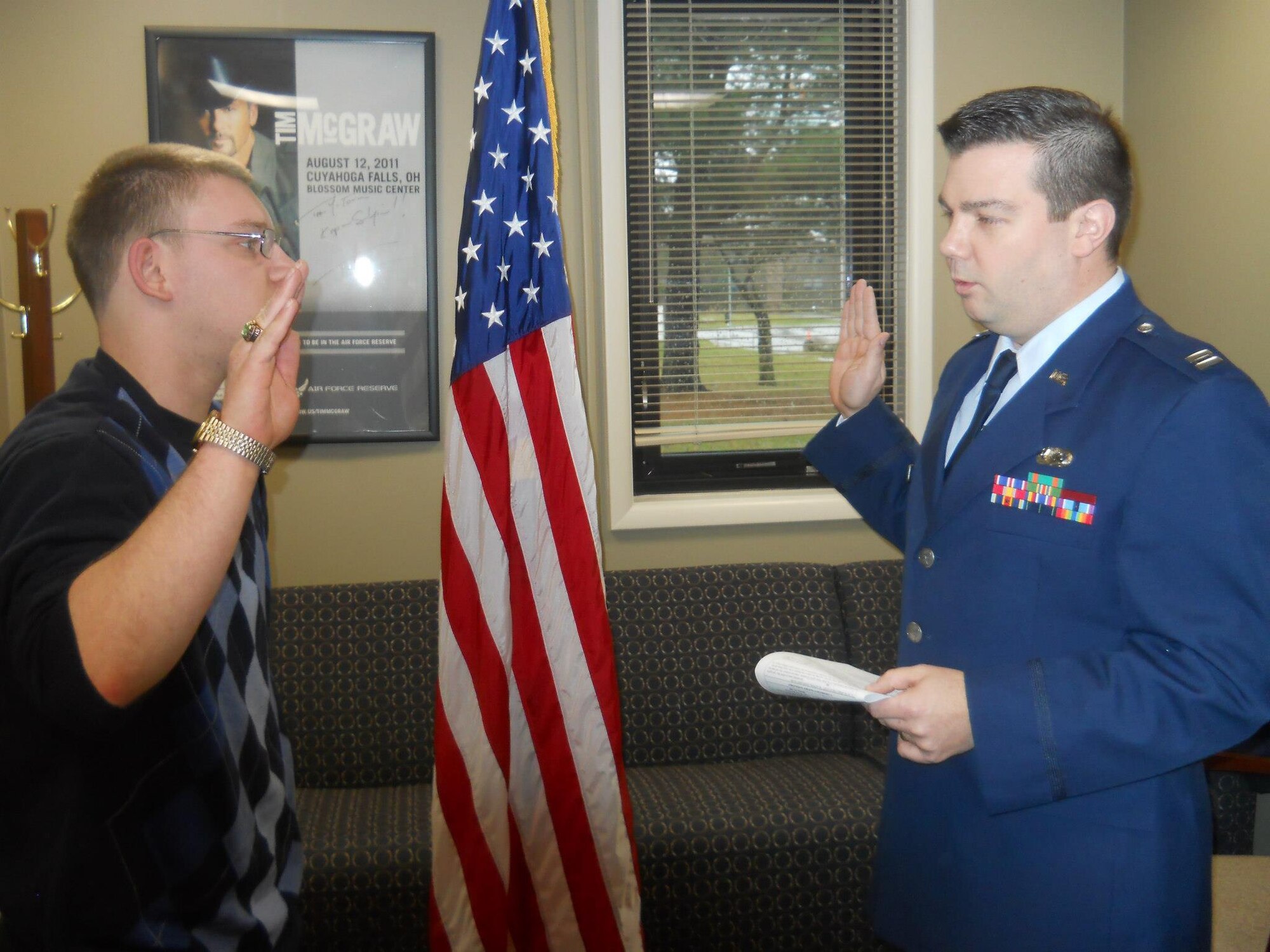 Adam Walleck recites the oath of enlistment, administered by his cousin, Capt. Shawn M. Walleck Jan. 30, 2012 at the Youngstown Air Reserve Station in Warren, Ohio.  Adam will serve the 179th Airlift Wing in Mansfield, Ohio for the Ohio Air National Guard as a Command Post Journeyman and Capt. Walleck currently serves the 911th Airlift Wing as the Chief of Public Affairs.  Both Wallecks' fathers served locally for the 171st Air Refueling Wing, with the family's military roots tracing back to World War I.  (courtesy photo)