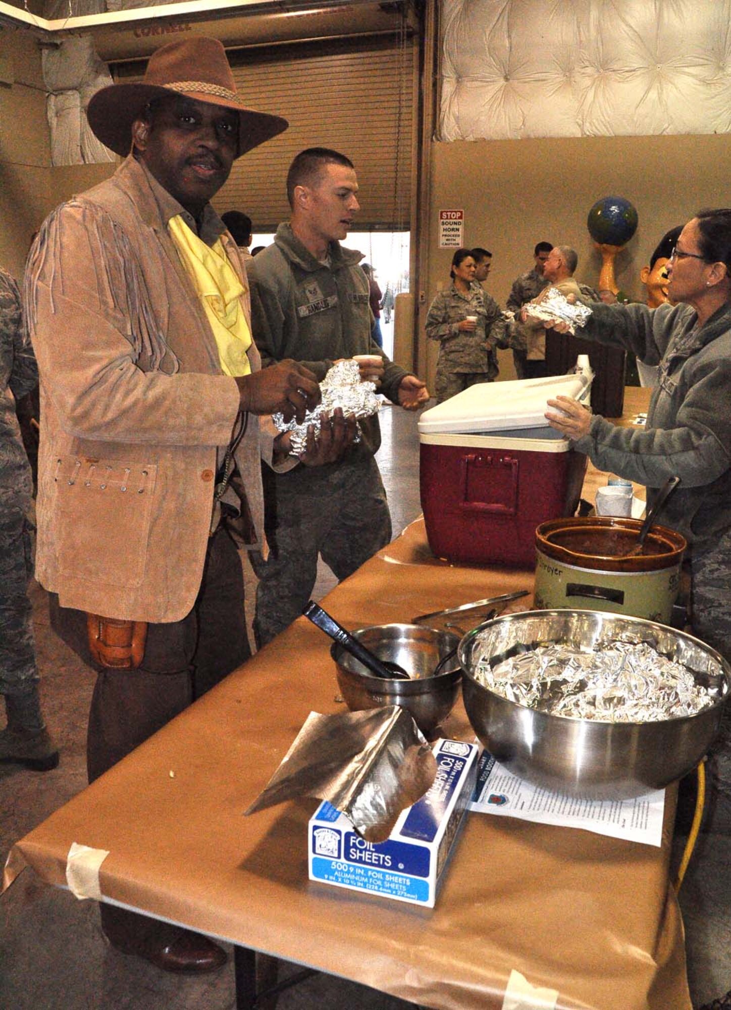 Dressed in rodeo attire, Tech. Sgt. Alfred Johnson, 433rd Maintenance Squadron’s Structural Repair Shop, grabs his burritos at the 13th Annual Rodeo Round-Up Breakfast at Joint Base San Antonio-Lackland Feb. 14. The free breakfast is a spin-off of the annual San Antonio Stock & Rodeo Show. (U.S. Air Force photo by 1st Lt. Denise Haeussler)