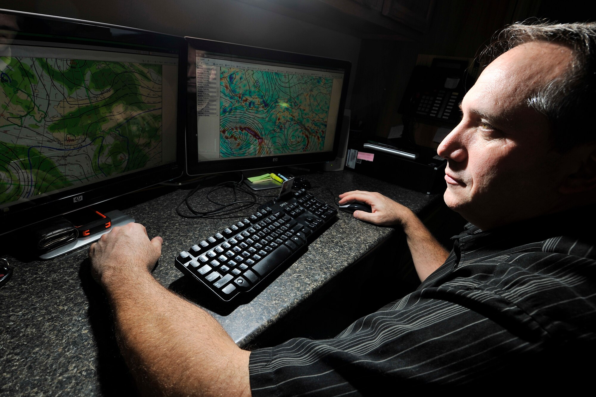 Don Gossel, 354th Operations Support Squadron lead meteorologist, compares lower and upper model data of weather patterns Feb. 6, 2013, Eielson Air Force Base, Alaska. The Iceman weather team, consisting of 10 active duty personnel and one civilian, supports the base by updating base agencies with critical weather knowledge, to include snow, freezing precipitation, thunderstorms, hail and wind speeds. (U.S. Air Force photo/Senior Airman Racheal E. Watson)