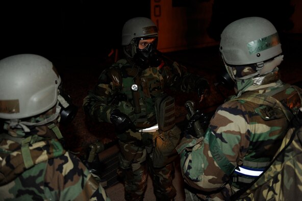 Master Sgt. Gilles Brochu, left, 8th Comptroller Squadron exercise evaluation team, checks the knowledge of Tech. Sgt. Luis Navarro-Figueroa, middle, and Staff Sgt. Ismael Tabual, 8th Comptroller Squadron, for proper procedures during an initial post-attack reconnaissance sweep during exercise Beverly Bulldog 13-2 at Kunsan Air Base, Republic of Korea, Feb. 14, 2013. PAR teams are used after an attack to check for casualties, unexploded ordnance, contamination from chemical, biological, radiological, nuclear or explosive weapons, and damage to structures and equipment. (U.S. Air Force photo by Senior Airman Marcus Morris/Released)