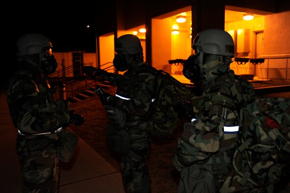 Master Sgt. Gilles Brochu, left, 8th Comptroller Squadron exercise evaluation team, checks the knowledge of Tech. Sgt. Luis Navarro-Figueroa, middle, and Staff Sgt. Ismael Tabual, 8th Comptroller Squadron, for proper procedures during an initial post-attack reconnaissance sweep during exercise Beverly Bulldog 13-2 at Kunsan Air Base, Republic of Korea, Feb. 14, 2013. PAR teams are used after an attack to check for casualties, unexploded ordnance, contamination from chemical, biological, radiological, nuclear or explosive weapons, and damage to structures and equipment. (U.S. Air Force photo by Senior Airman Marcus Morris/Released)