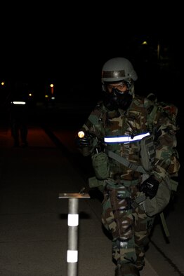 Staff Sgt. Ismael Tabual, 8th Comptroller Squadron, checks M-8 paper while performing post-attack reconnaissance sweep during exercise Beverly Bulldog 13-2 at Kunsan Air Base, Republic of Korea, Feb. 14, 2013. PAR teams are used after an attack to check for casualties, unexploded ordnance, contamination from chemical, biological, radiological, nuclear or explosive weapons, and damage to structures and equipment. (U.S. Air Force photo by Senior Airman Marcus Morris/Released)