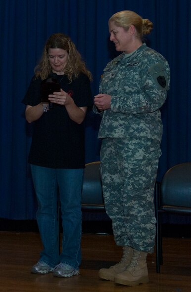 U.S. Army Col.  Jayne Jansen, 633rd Air Base Wing vice commander, accepts an award from a Special Olympian Feb. 9 at Langley Air Force Base, Va., before the Special Olympics basketball tournament. The Special Olympics staff also gave an award to the entire base and the 633rd Force Support Squadron for supporting the event. (U.S. Air Force photo by Airman 1st Class Austin Harvill/Released)