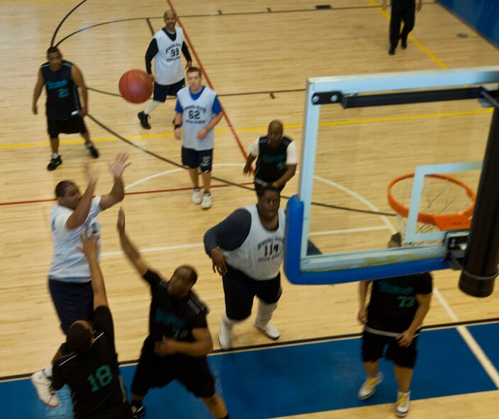 A Special Olympian shoots a fade away under a tight defense Feb. 9 at Langley Air Force Base, Va., during the Special Olympics basketball tournament. Langley hosted multiple teams from across the Hampton Roads area. (U.S. Air Force photo by Airman 1st Class Austin Harvill/Released)