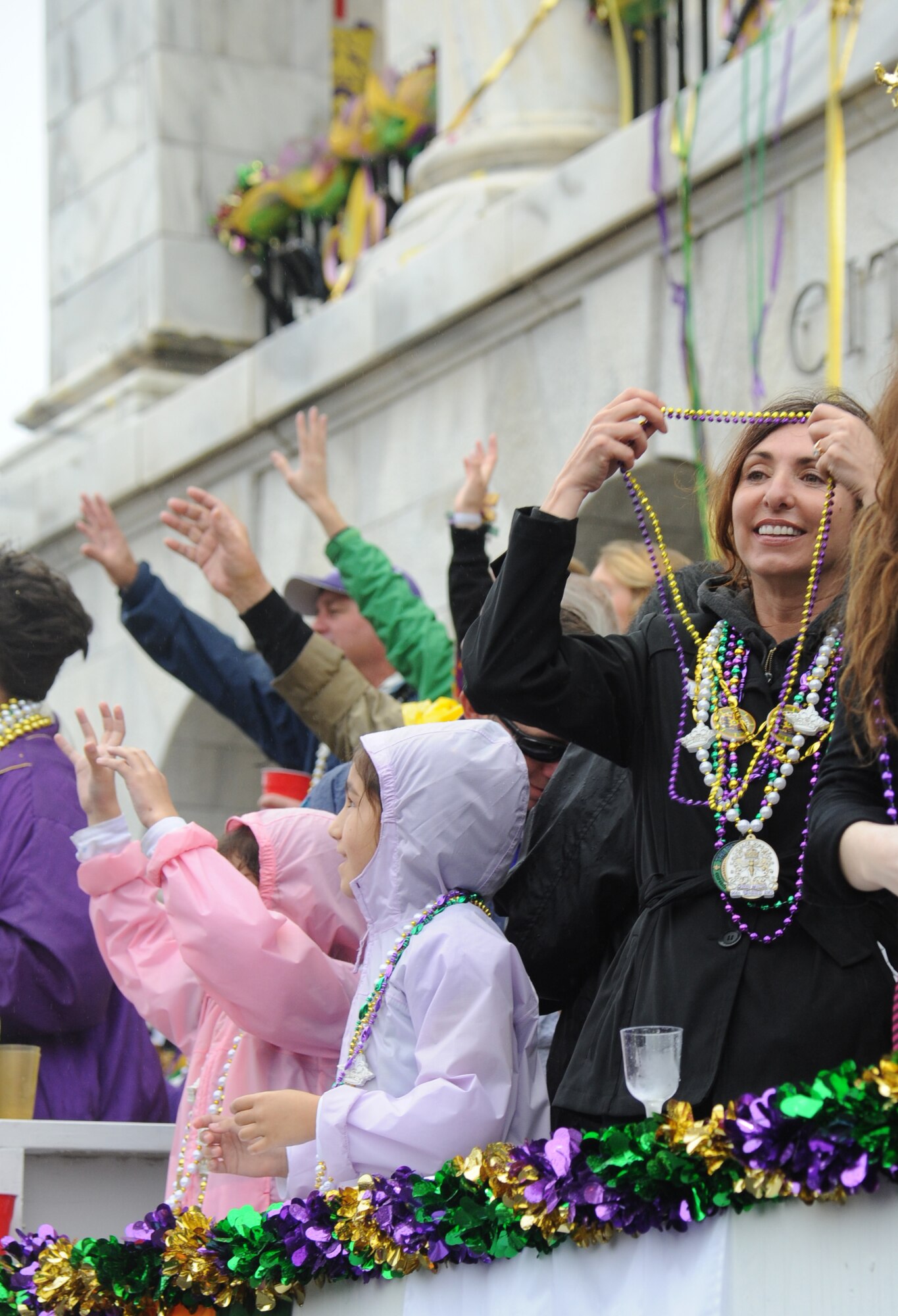 Lisa Spacy, spouse of Brig. Gen. Brad Spacy, 81st Training Wing commander, enjoys the Gulf Coast Carnival Association Mardi Gras with the general from city hall parade in Biloxi, Miss., Feb. 12, 2013.  Col. Craig LaFave, 403rd Wing commander, and the Keesler Honor Guard also participated in the festivities.  (U.S. Air Force photo by Kemberly Groue)