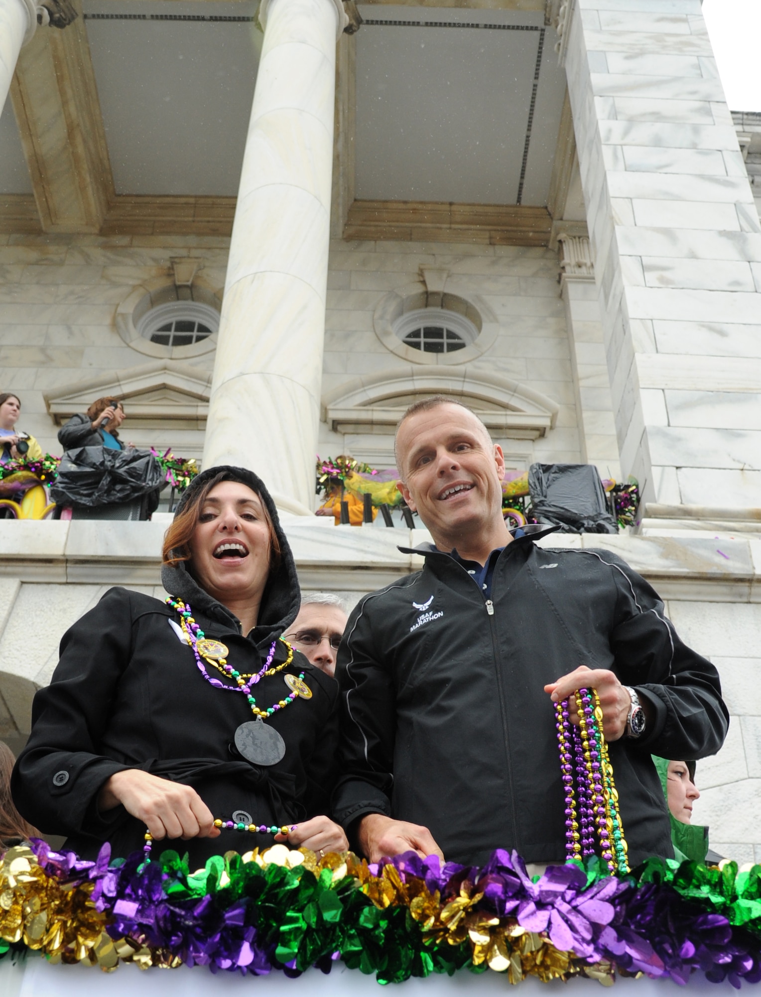 Lisa and Brig. Gen. Brad Spacy, 81st Training Wing commander, enjoy the Gulf Coast Carnival Association Mardi Gras parade from city hall in Biloxi, Miss., Feb. 12, 2013.  The Keesler Honor Guard also participated in the festivities.  (U.S. Air Force photo by Kemberly Groue)