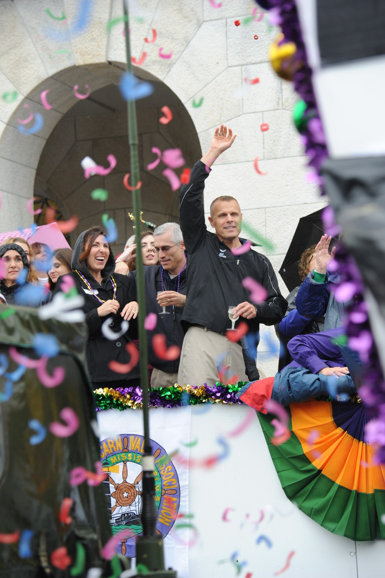 Col. Craig LaFave, 403rd Wing commander, center, and Lisa and Brig. Gen. Brad Spacy, 81st Training Wing commander, enjoy the Gulf Coast Carnival Association Mardi Gras parade from city hall in Biloxi, Miss., Feb. 12, 2013.  The Keesler Honor Guard also participated in the festivities.  (U.S. Air Force photo by Kemberly Groue)