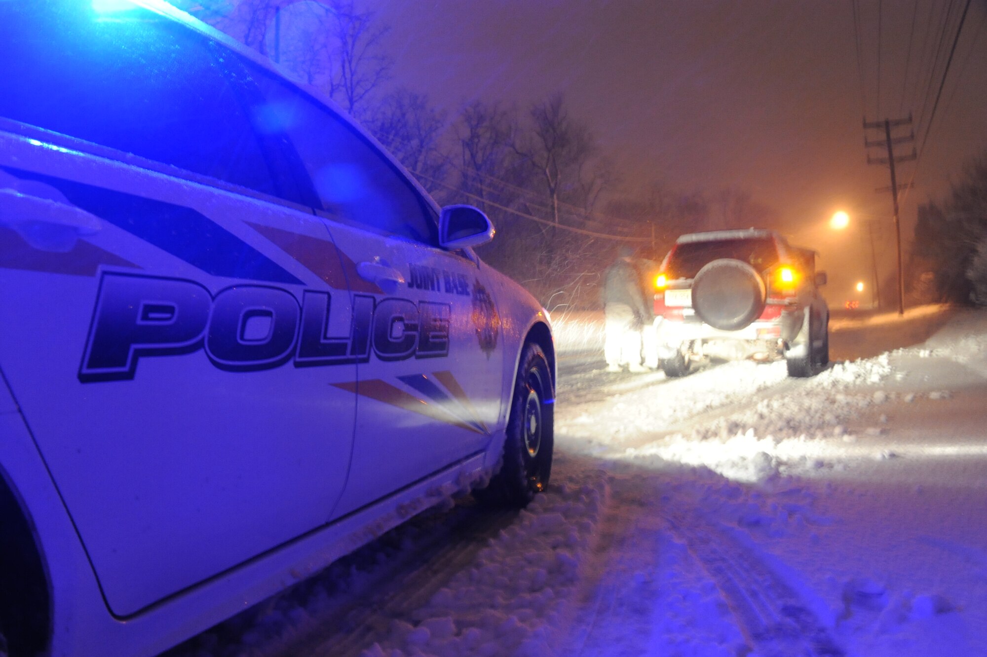 Tech. Sgt. Peter Ranjo, 87th Security Forces Squadron flight sergeant, assists a stranded motorist Feb. 9, 2013, at Joint Base McGuire-Dix-Lakehurst, N.J. Security forces members work 24/7 to ensure the safety of the joint base’s 42,000 acres. (U.S. Air Force photo by Airman Sean M. Crowe/Released)