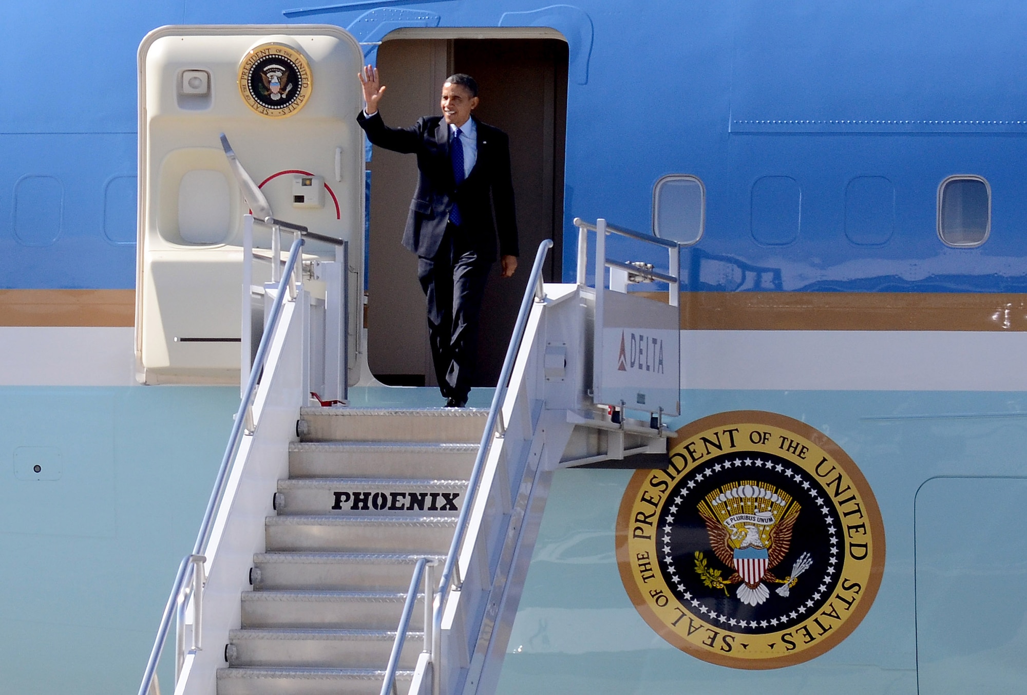 President Barack Obama waves from Air Force One to a small crowd of excited guests, upon his arrival at Dobbins Air Reserve Base, Marietta, Ga., Feb. 14.  The president is going to the City of Decatur Recreation Center today to discuss proposals outlined in his state of the union speech on Tuesday.  (U.S. Air Force photo/ Brad Fallin)