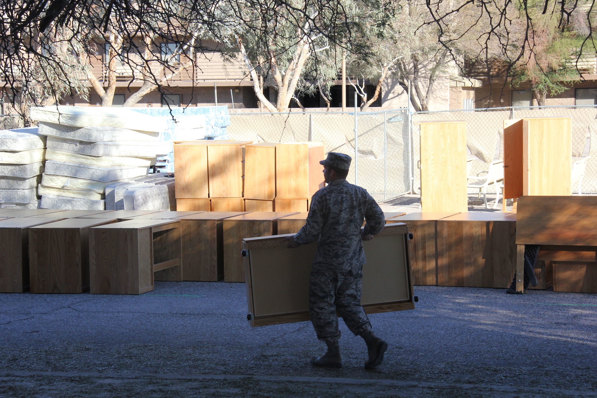 Technical Sgt. Ian Lutjens, 355th Contracting Squadron, carries furniture out of an empty dorm on Davis-Monthan Air Force Base. The furniture donations will help Tucson meet its goal of housing an additional 75 homeless veterans this year. (Courtesy Photo)