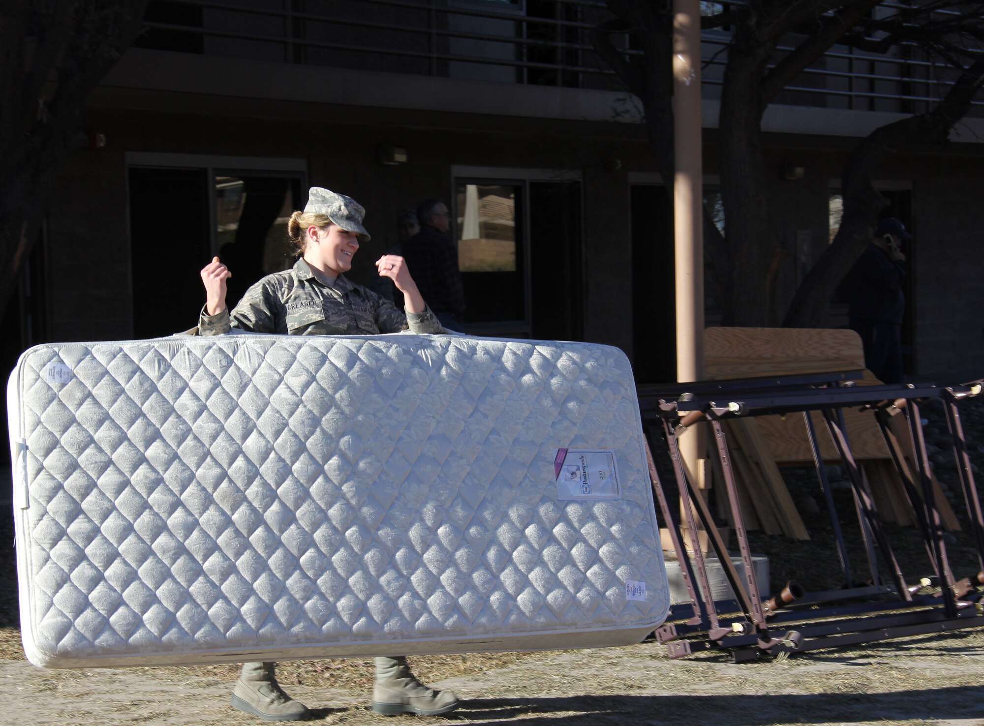Senior Airman Macy Creager, 355th Contracing Squadron, carries a dorm mattress that will be donated to homeless veterans. (Courtesy Photo)