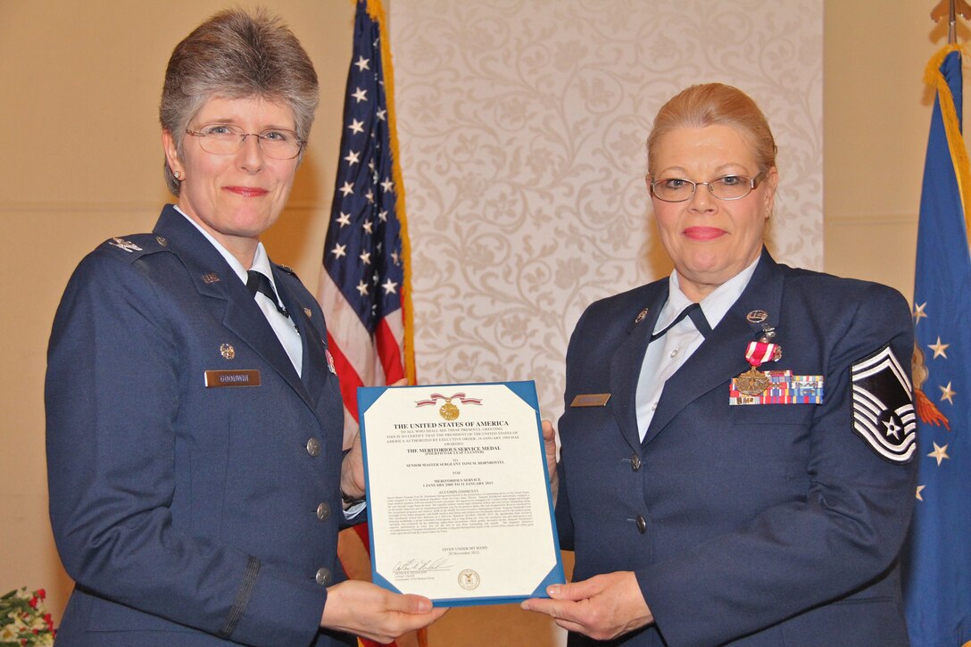 Col. Meredith Goodwin, commander of the 932nd Medical Squadron, (MDS) presents Senior Master Sgt. Toni Hornbostel the Air Force Meritorious Service Medal at her retirement ceremony held Feb. 9, 2013. Hornbostel has had an illustrious military career that began in 1975.  Hornbostel has deployed overseas and participated in numerous exercises and humanitarian missions.  She served a total of 38 years--all in the medical services career field. Hornbostel was assigned a variety of medical positions during her time at the 932nd Airlift Wing.  She was the senior ART (air reserve technician) at the 932nd Aerospace Medical Squadron for four years; and has been the senior ART for the 932nd MDS Squadron since 2004.  (U.S. Air Force photo/Tech. Sgt. Dan Oliver)